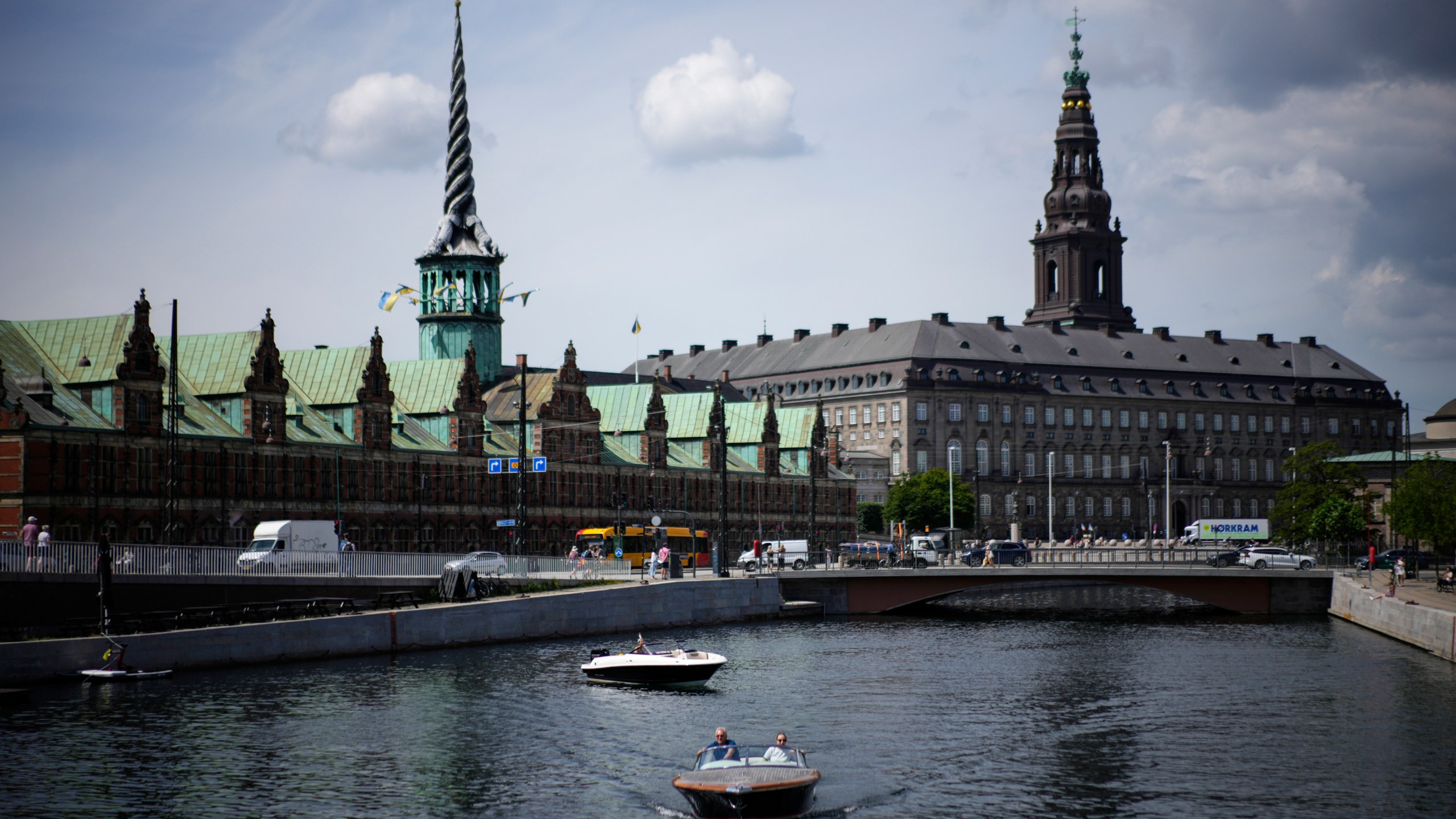 FILE - A boat wades through the Nyhavn river, with the Old Stock Exchange building left in the background, in Copenhagen, Denmark, on June 29, 2022. (AP Photo/Daniel Cole, File)