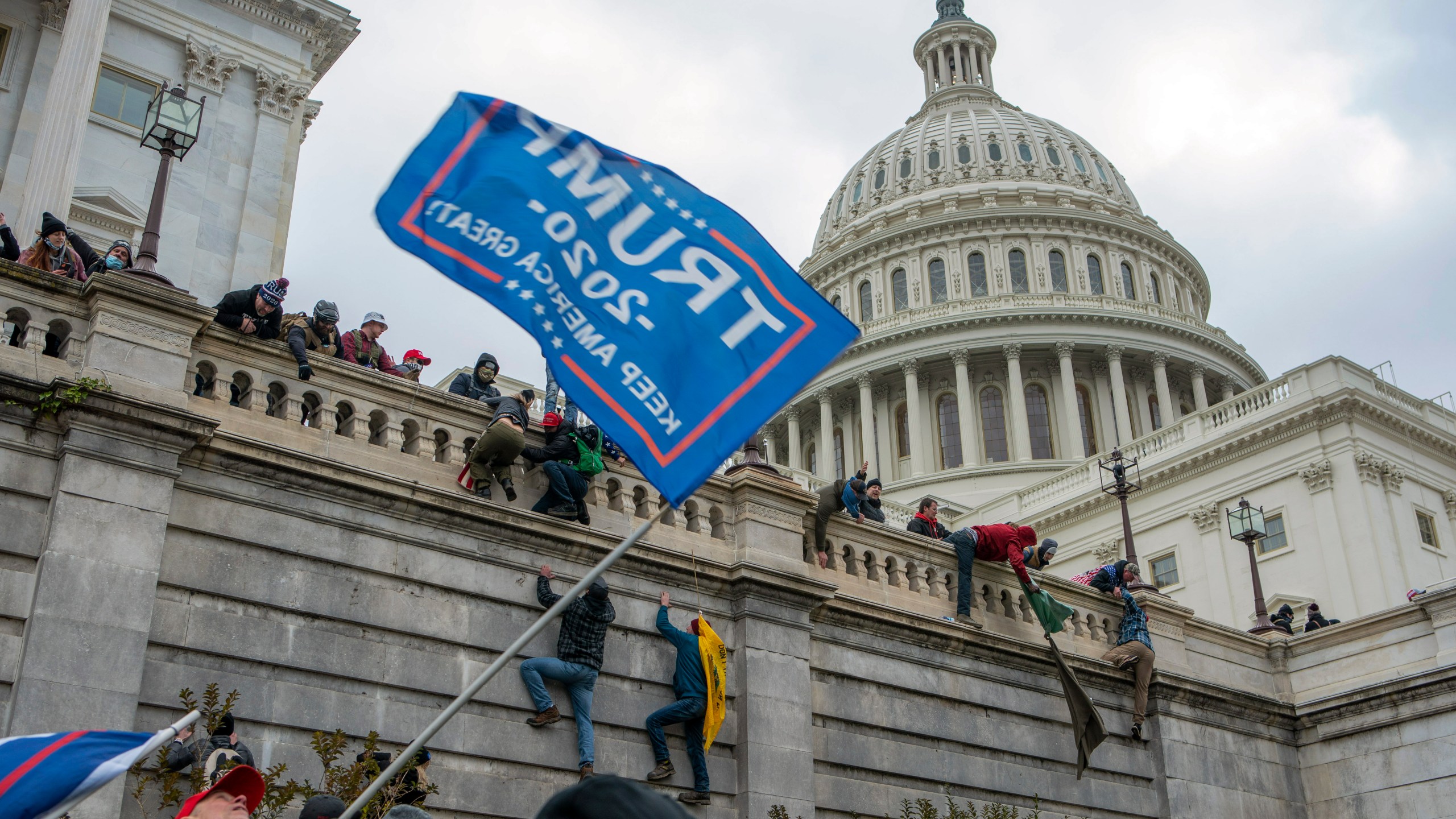 FILE - Support of President Donald Trump climb the West wall of the the U.S. Capitol, Jan. 6, 2021, in Washington. (AP Photo/Jose Luis Magana, File)