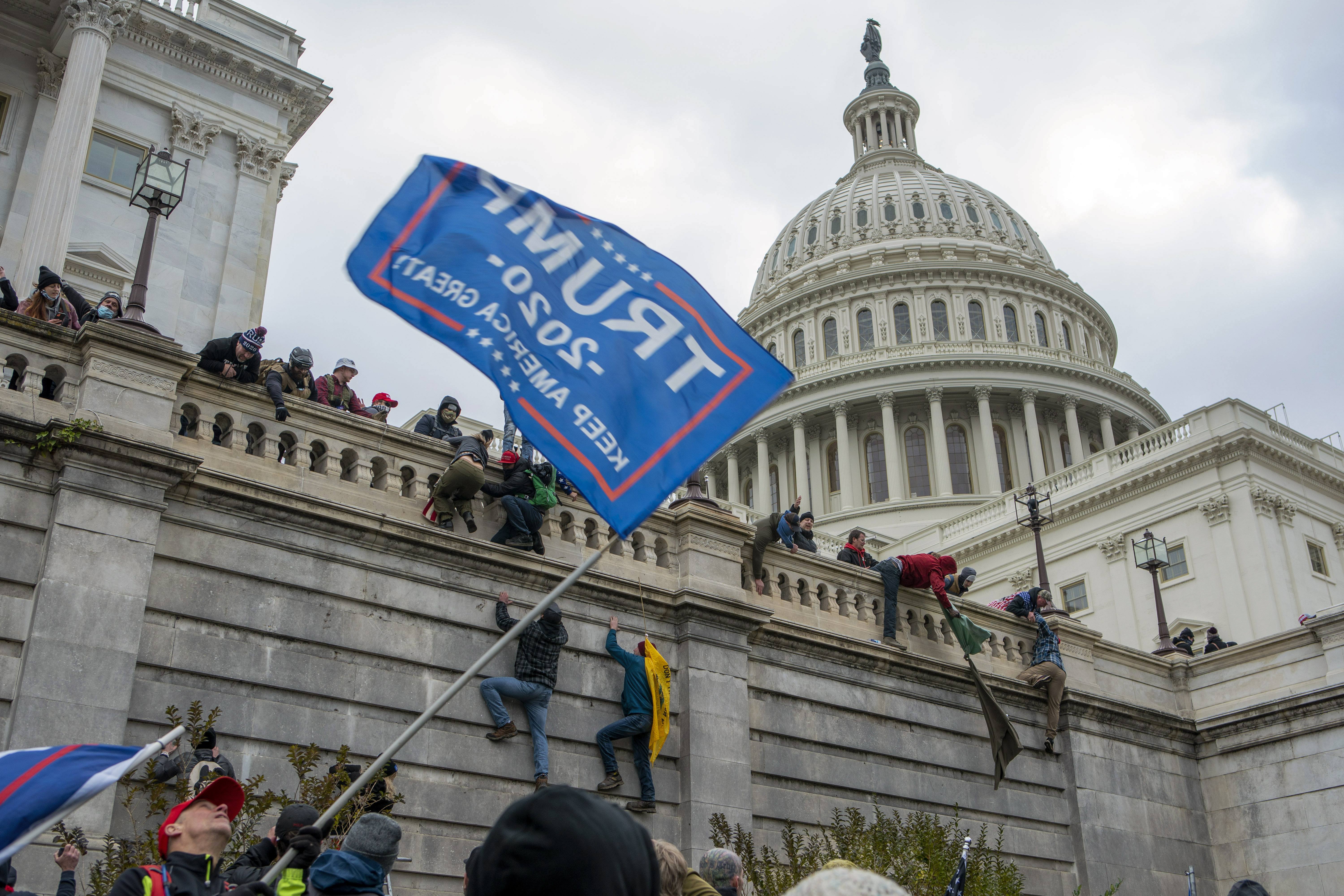 FILE - Support of President Donald Trump climb the West wall of the the U.S. Capitol, Jan. 6, 2021, in Washington. (AP Photo/Jose Luis Magana, File)