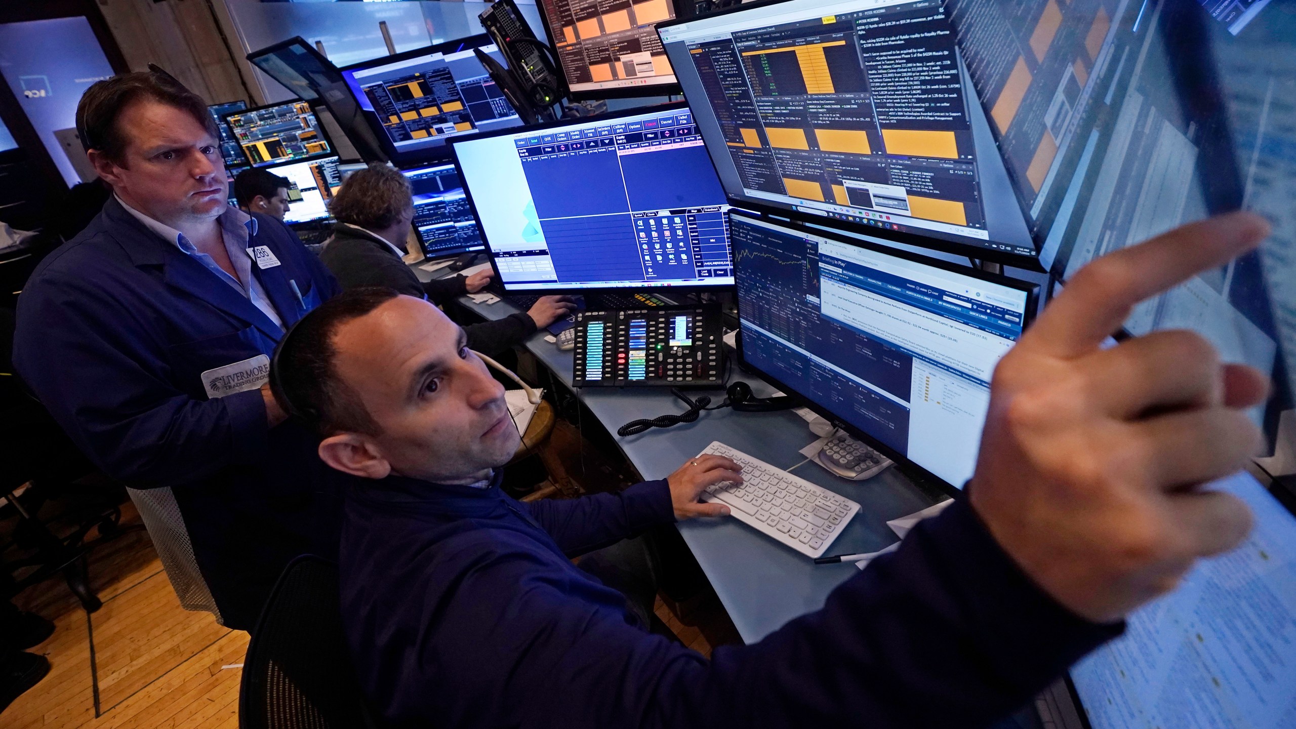 A pair of traders work in their booth on the floor of the New York Stock Exchange, Thursday, Nov. 7, 2024. (AP Photo/Richard Drew)