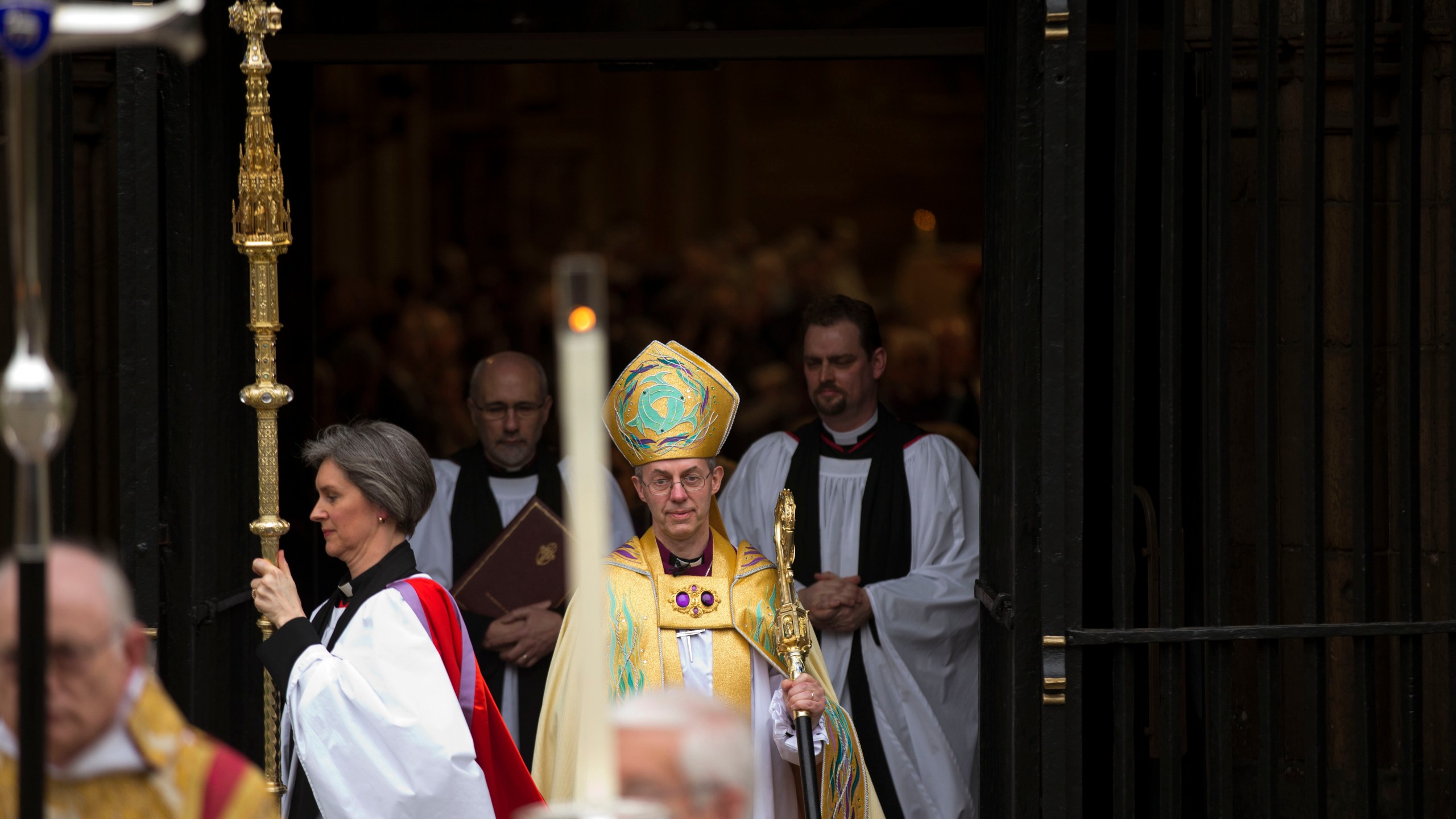 FILE - Britain's new Archbishop of Canterbury Justin Welby, center, leaves after his enthronement ceremony at Canterbury Cathedral in Canterbury, England, Thursday, March 21, 2013. (AP Photo/Matt Dunham, File)