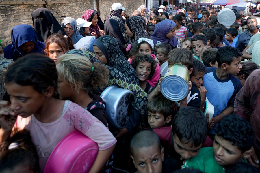 FILE - Palestinians line up for food distribution in Deir al-Balah, Gaza Strip, on Oct. 17, 2024. (AP Photo/Abdel Kareem Hana, File)