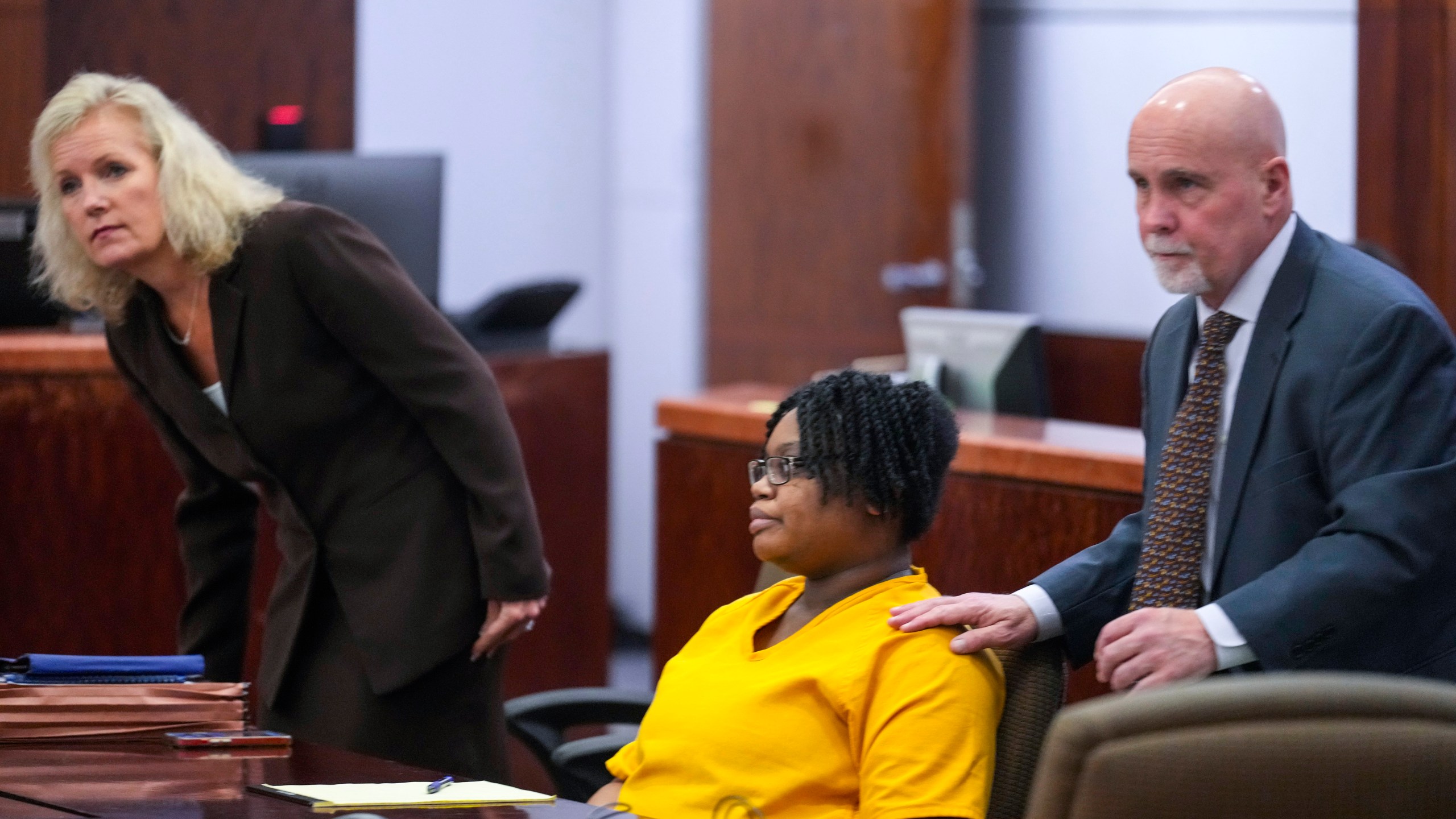 Defendant Gloria Williams, charged in connection with the death of her 8-year-old son, whose skeletal remains decomposed for months inside a Houston-area apartment with three surviving but abandoned siblings, and her lawyers, Beth Exley, left, and Neal Davis III, appear for a hearing, Tuesday, Nov. 12, 2024, at the Harris County Criminal Justice Center in Houston. (Brett Coomer/Houston Chronicle via AP)