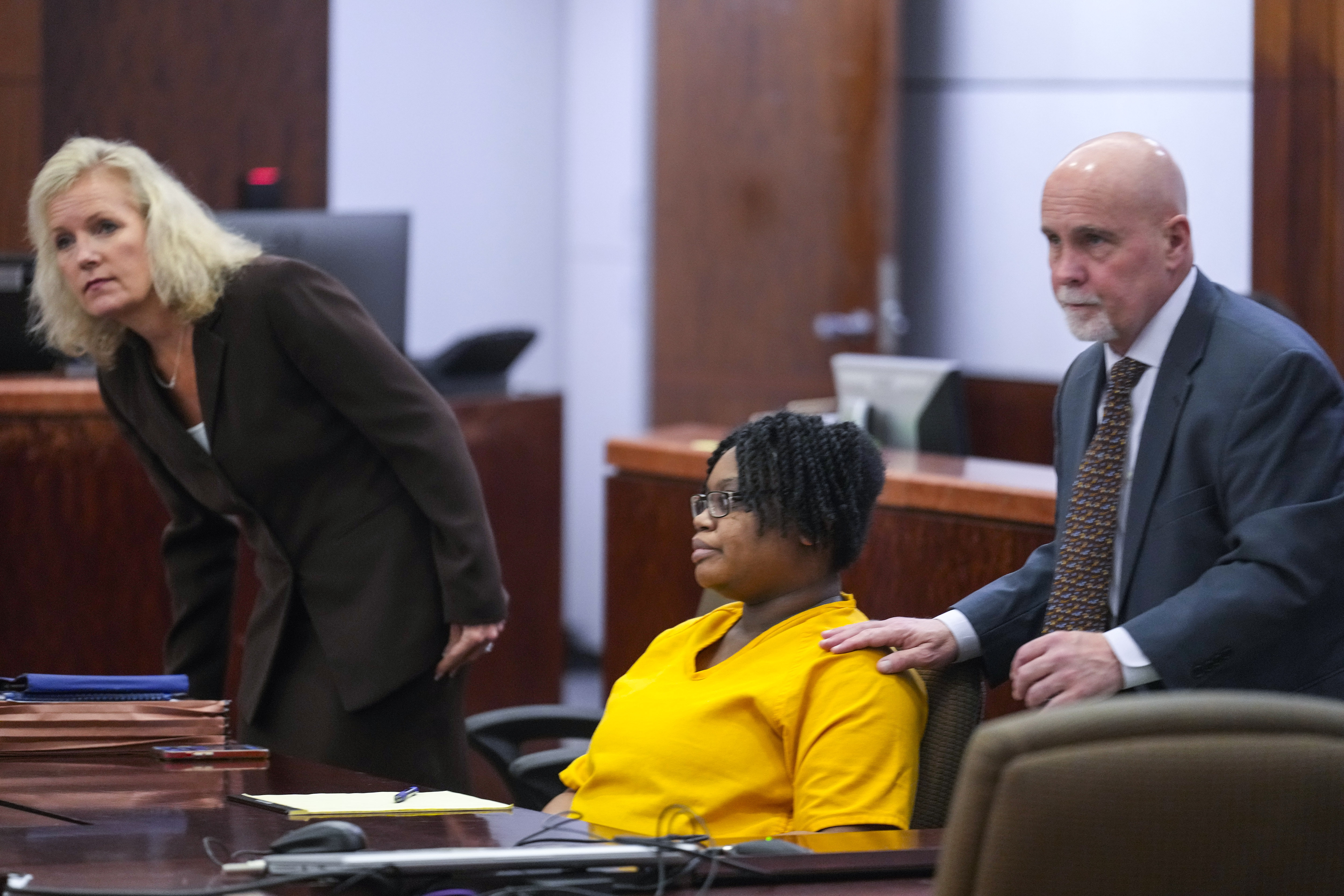 Defendant Gloria Williams, charged in connection with the death of her 8-year-old son, whose skeletal remains decomposed for months inside a Houston-area apartment with three surviving but abandoned siblings, and her lawyers, Beth Exley, left, and Neal Davis III, appear for a hearing, Tuesday, Nov. 12, 2024, at the Harris County Criminal Justice Center in Houston. (Brett Coomer/Houston Chronicle via AP)