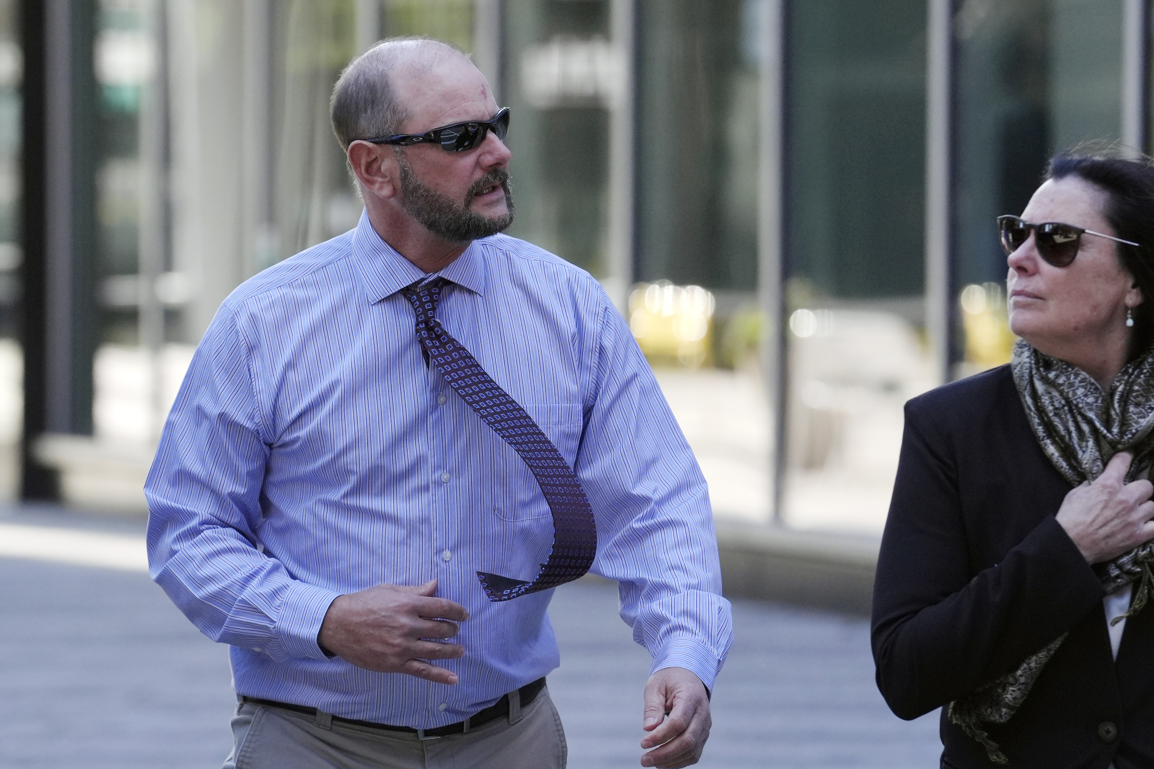 Jack Michael Teixeira, center, father of Massachusetts Air National Guardsman Jack Teixeira. arrives at federal court for his son's sentencing hearing, Tuesday, Nov. 12, 2024, in Boston,. (AP Photo/Steven Senne)