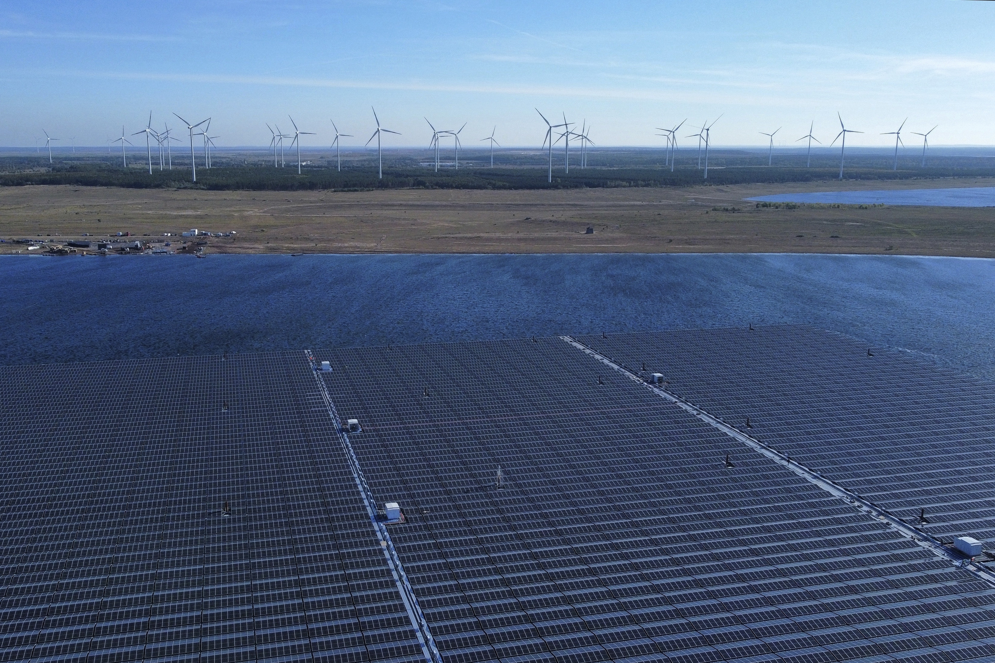 Floating solar panels operate on the Cottbuser Ostsee lake near Cottbus, Germany, Wednesday, Oct. 16, 2024. (AP Photo/Matthias Schrader)