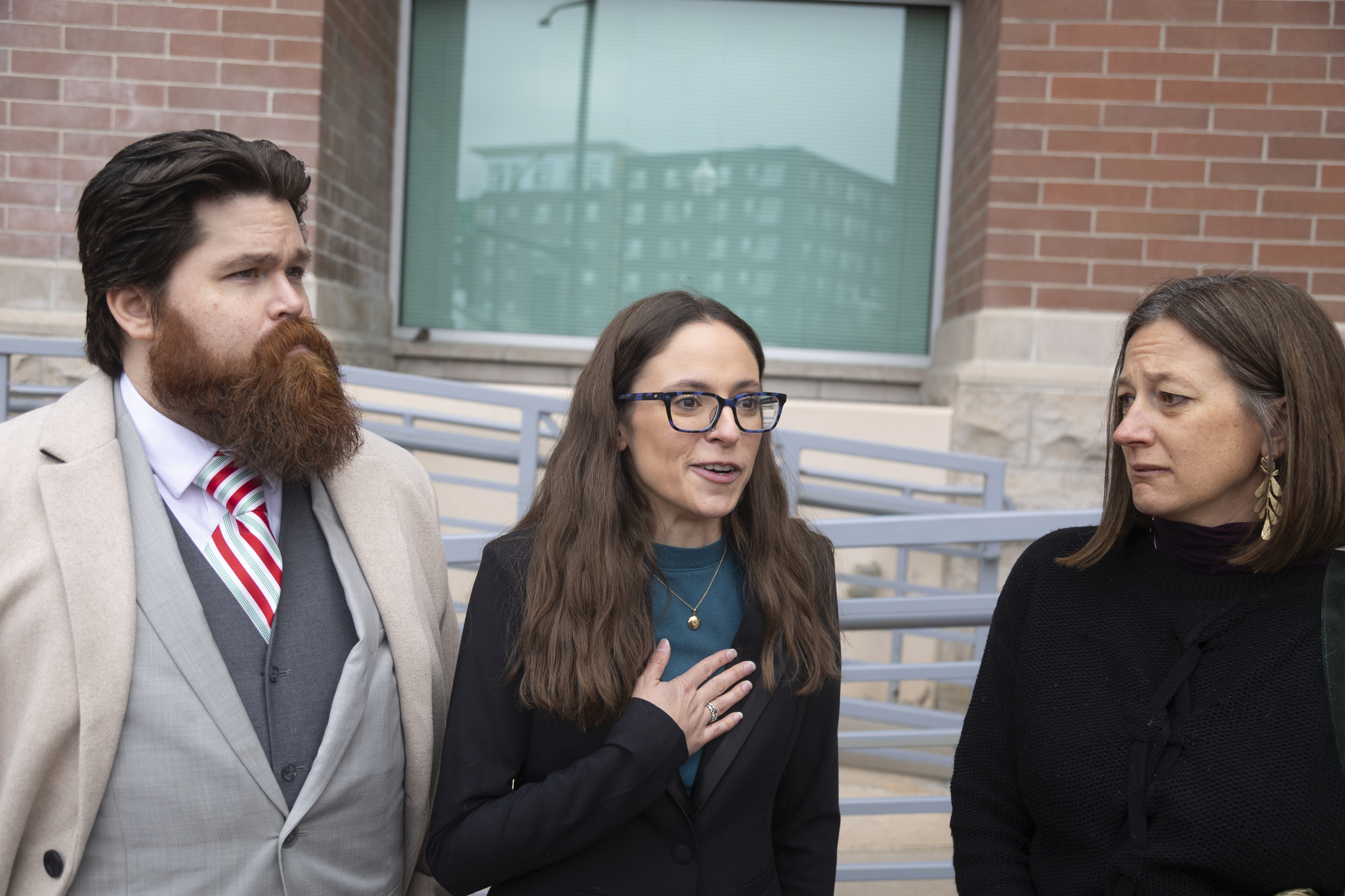 FILE - John Adkins, left to right, and his wife Jennifer, along with family physician Julie Lyons, talk to the media outside the Ada County Courthouse, Dec. 14, 2023, in Boise, Idaho. (AP Photo/Kyle Green, File)