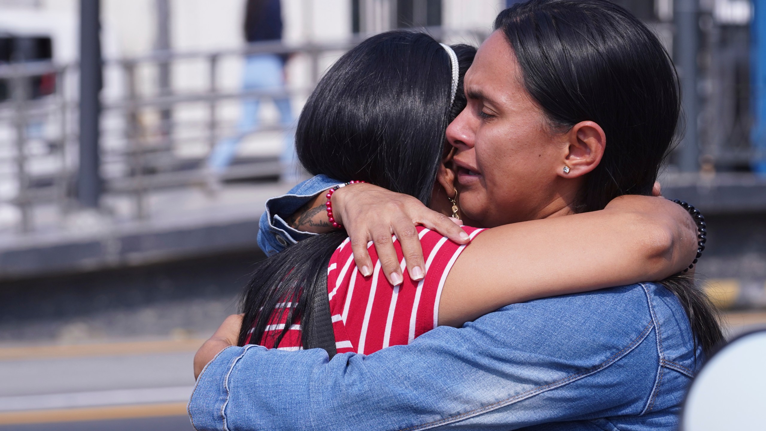 Inmates' relatives embrace outside the Litoral Penitentiary in the coastal city of Guayaquil, Ecuador, Tuesday, Nov. 12, 2024, where a fight among inmates has left at least more than a dozen dead authorities said. (AP Photo/Cesar Munoz)