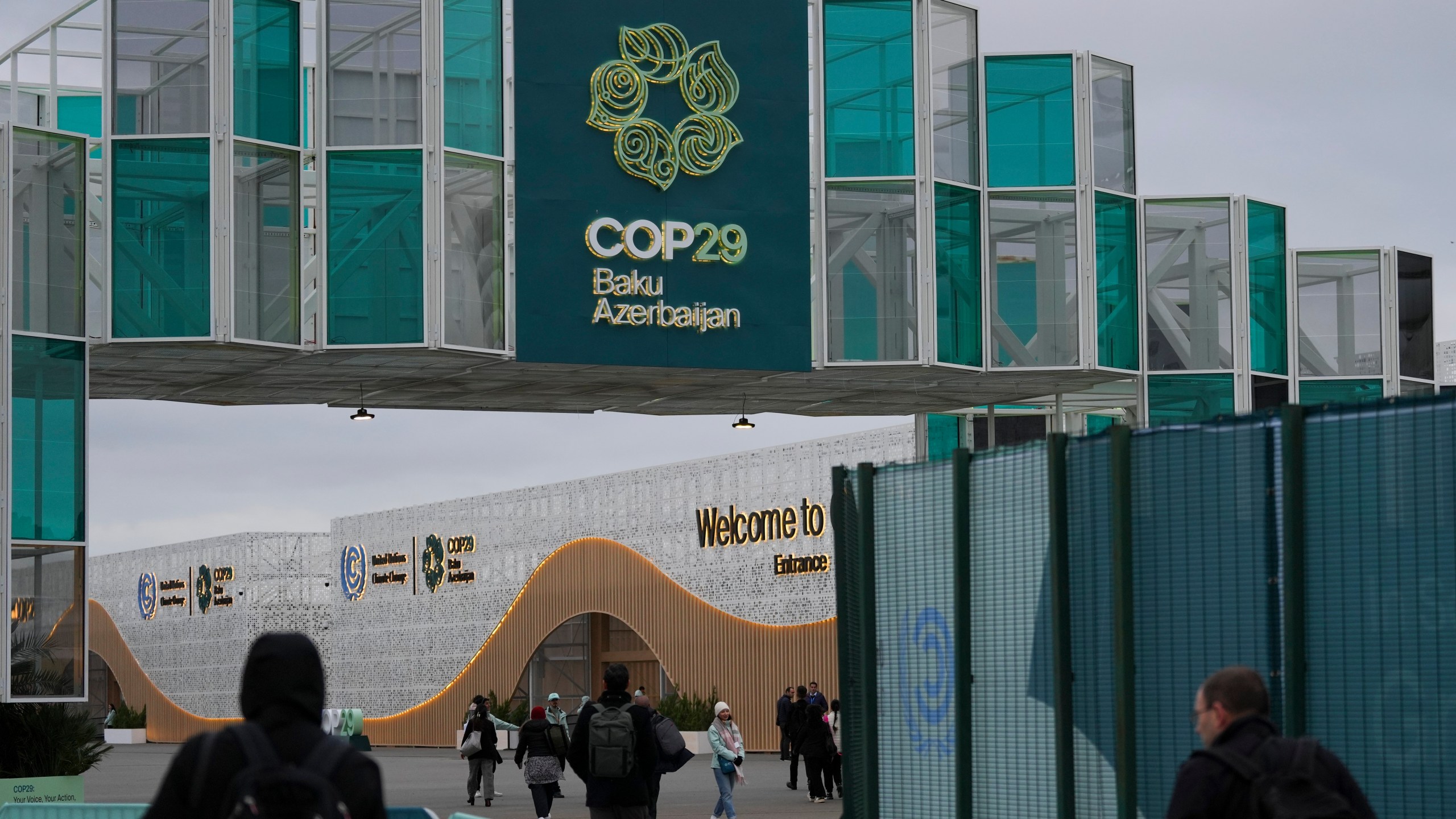 People arrive for the COP29 U.N. Climate Summit, Wednesday, Nov. 13, 2024, in Baku, Azerbaijan. (AP Photo/Peter Dejong)