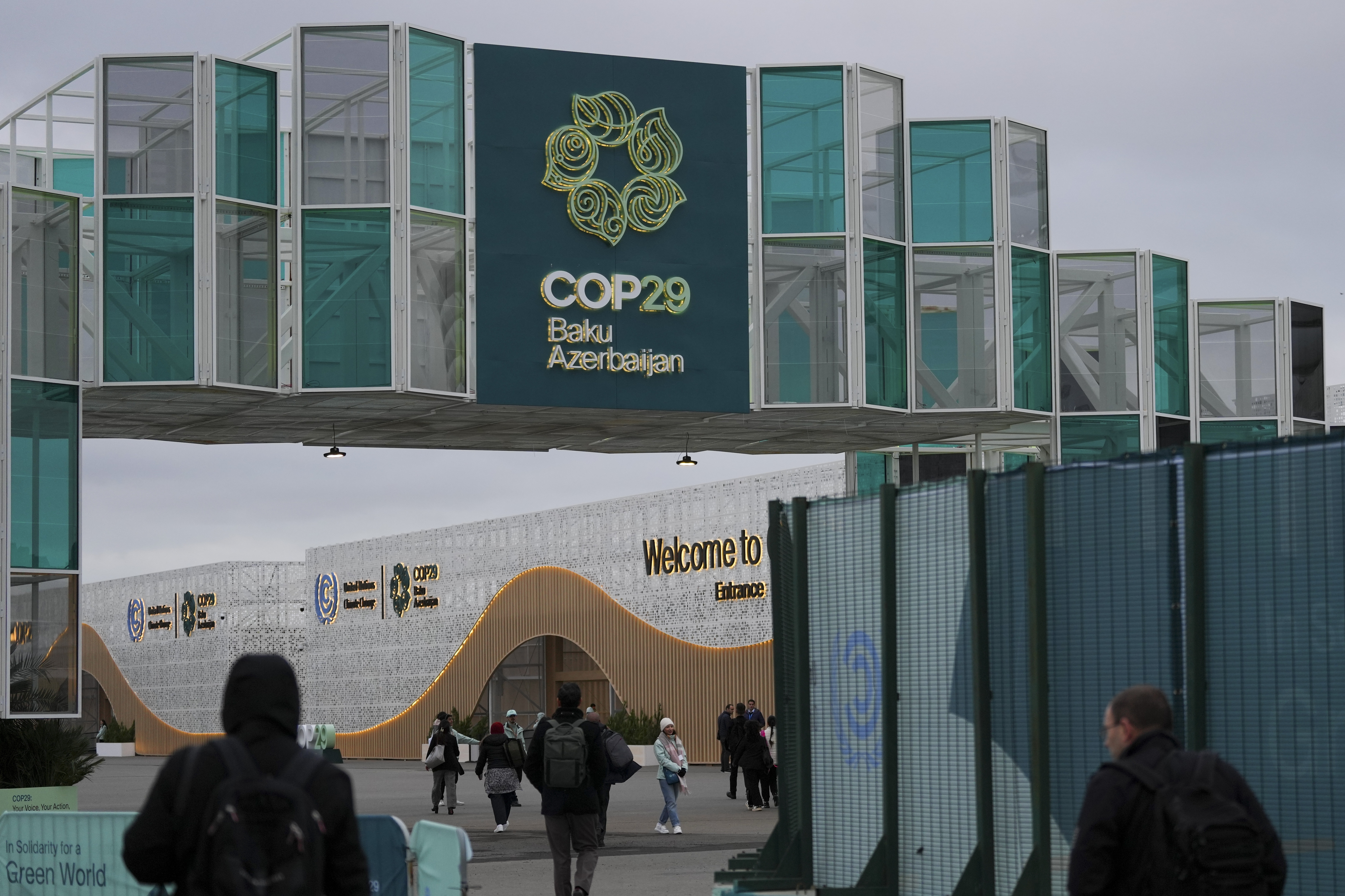 People arrive for the COP29 U.N. Climate Summit, Wednesday, Nov. 13, 2024, in Baku, Azerbaijan. (AP Photo/Peter Dejong)