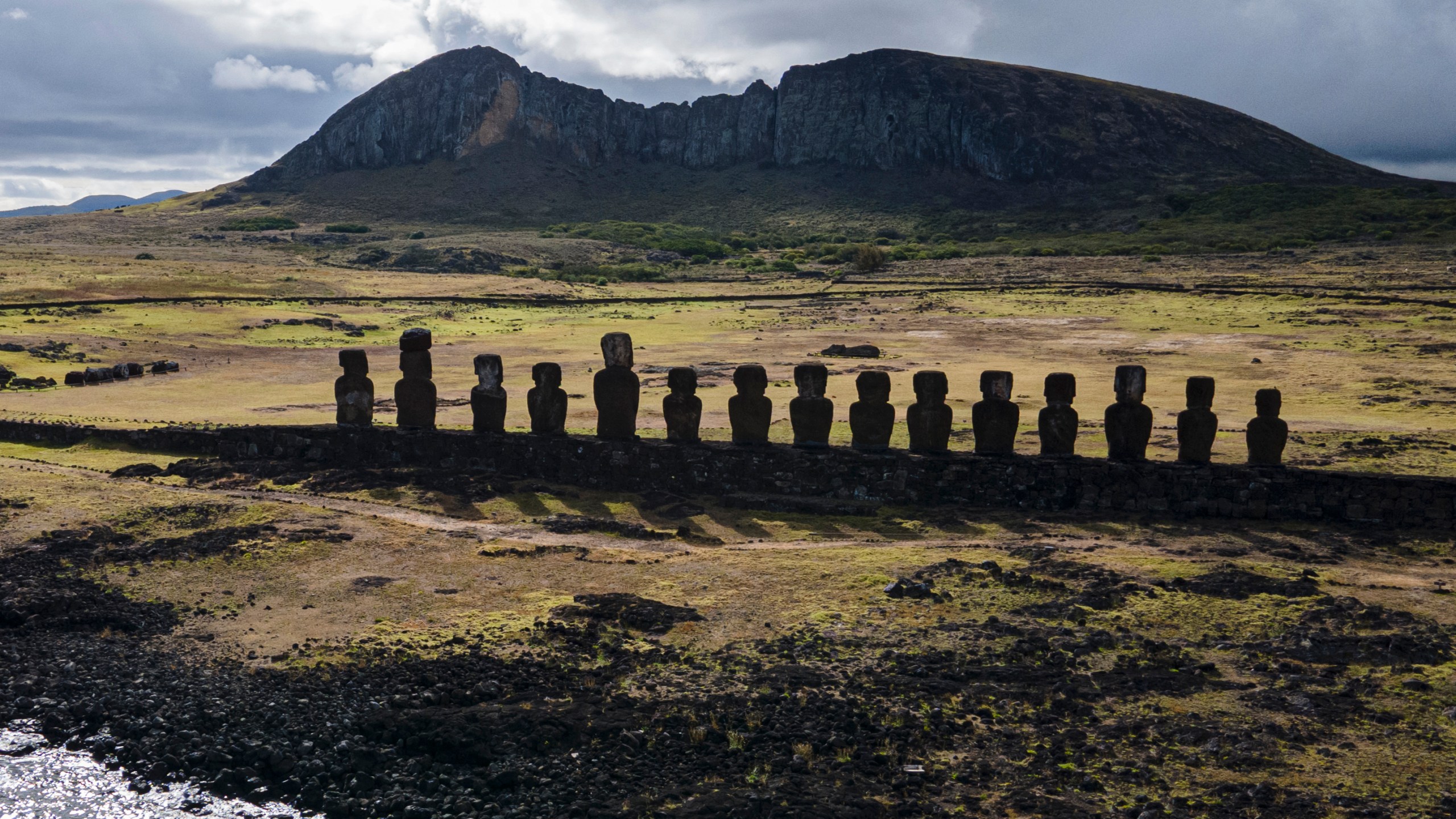 FILE - Moai statues stand on Ahu Tongariki near the Rano Raraku volcano, top, on Rapa Nui, or Easter Island, Chile, Nov. 27, 2022. (AP Photo/Esteban Felix, File)