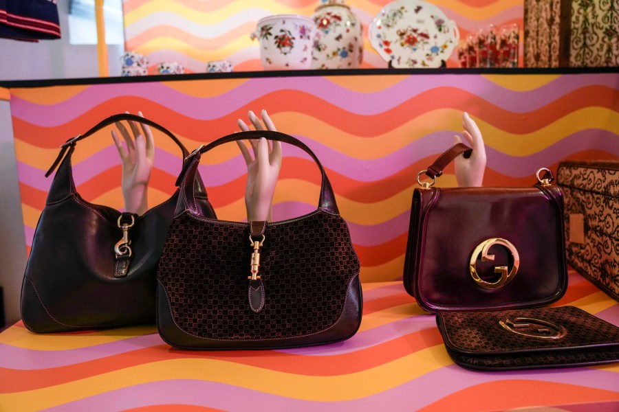 FILE - Vintage Gucci bags are displayed inside the new on-line concept store, called Gucci Vault, in Milan, Italy, Saturday, Sept. 25, 2021. (AP Photo/Luca Bruno, File)