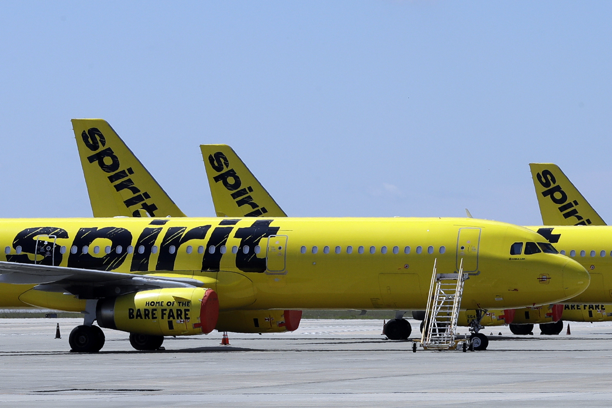 FILE - A line of Spirit Airlines jets sit on the tarmac at Orlando International Airport on May 20, 2020, in Orlando, Fla. (AP Photo/Chris O'Meara, File)