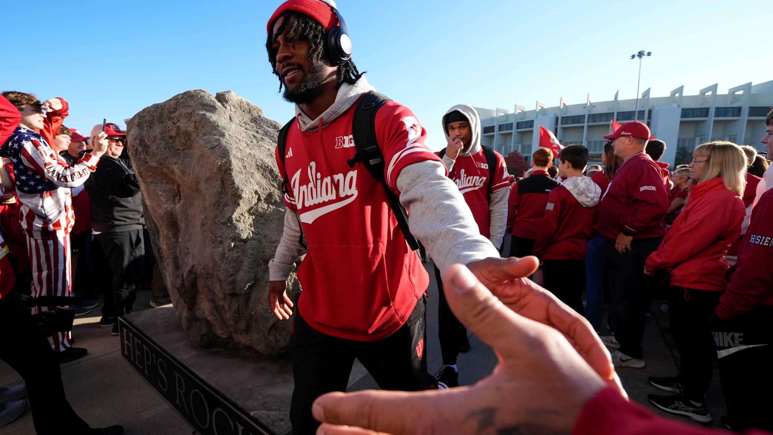 Indiana football players touch "Hep's Rock" and they enter Memorial Stadium before an NCAA college football game against the Washington, Saturday, Oct. 26, 2024, in Bloomington, Ind. (AP Photo/Darron Cummings)