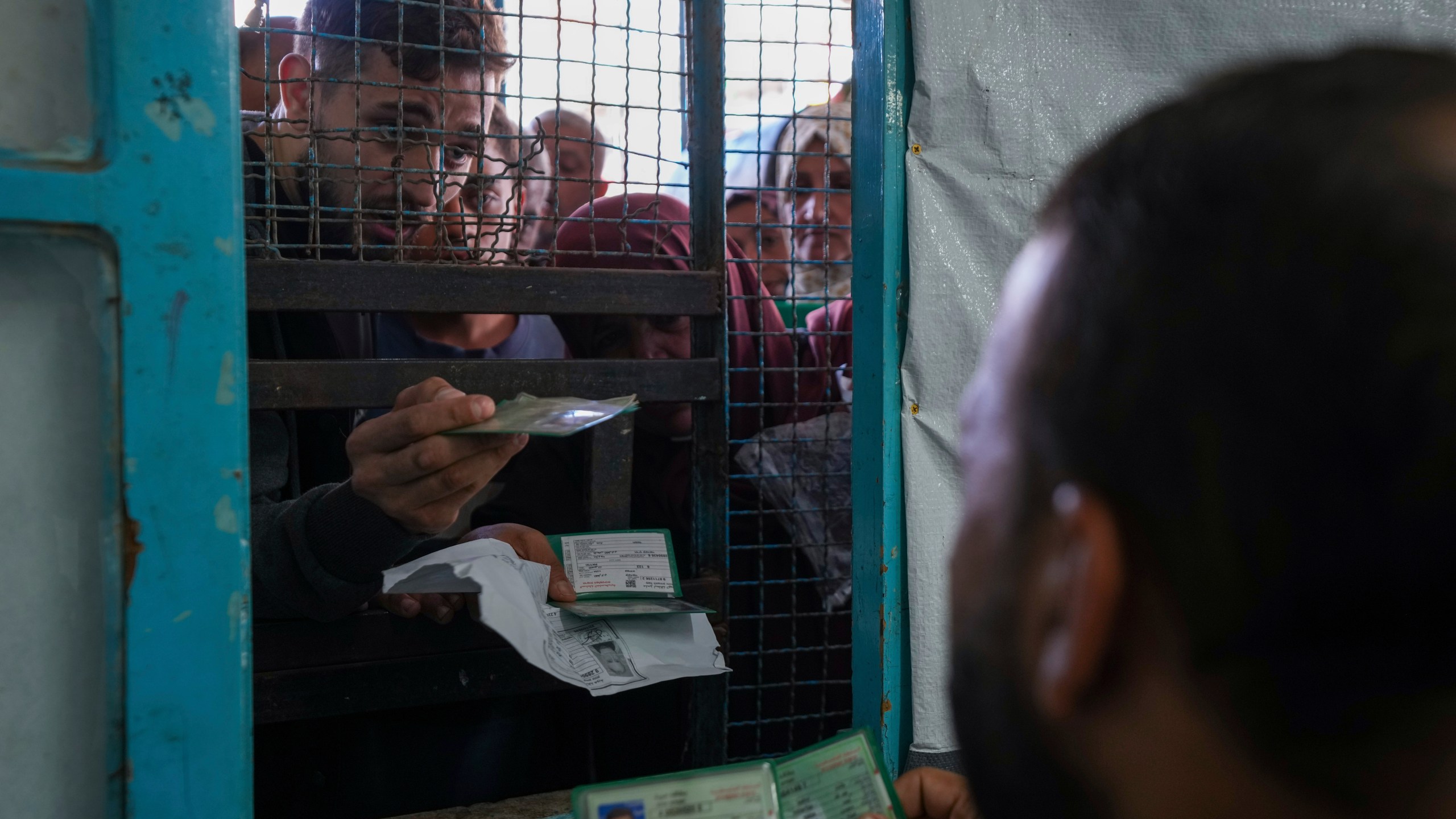 FILE - Palestinians line up to receive aid distributed by UNRWA, the U.N. agency helping Palestinian refugees, in Nusairat refugee camp, Gaza, on Nov. 5, 2024. (AP Photo/Abdel Kareem Hana, File)