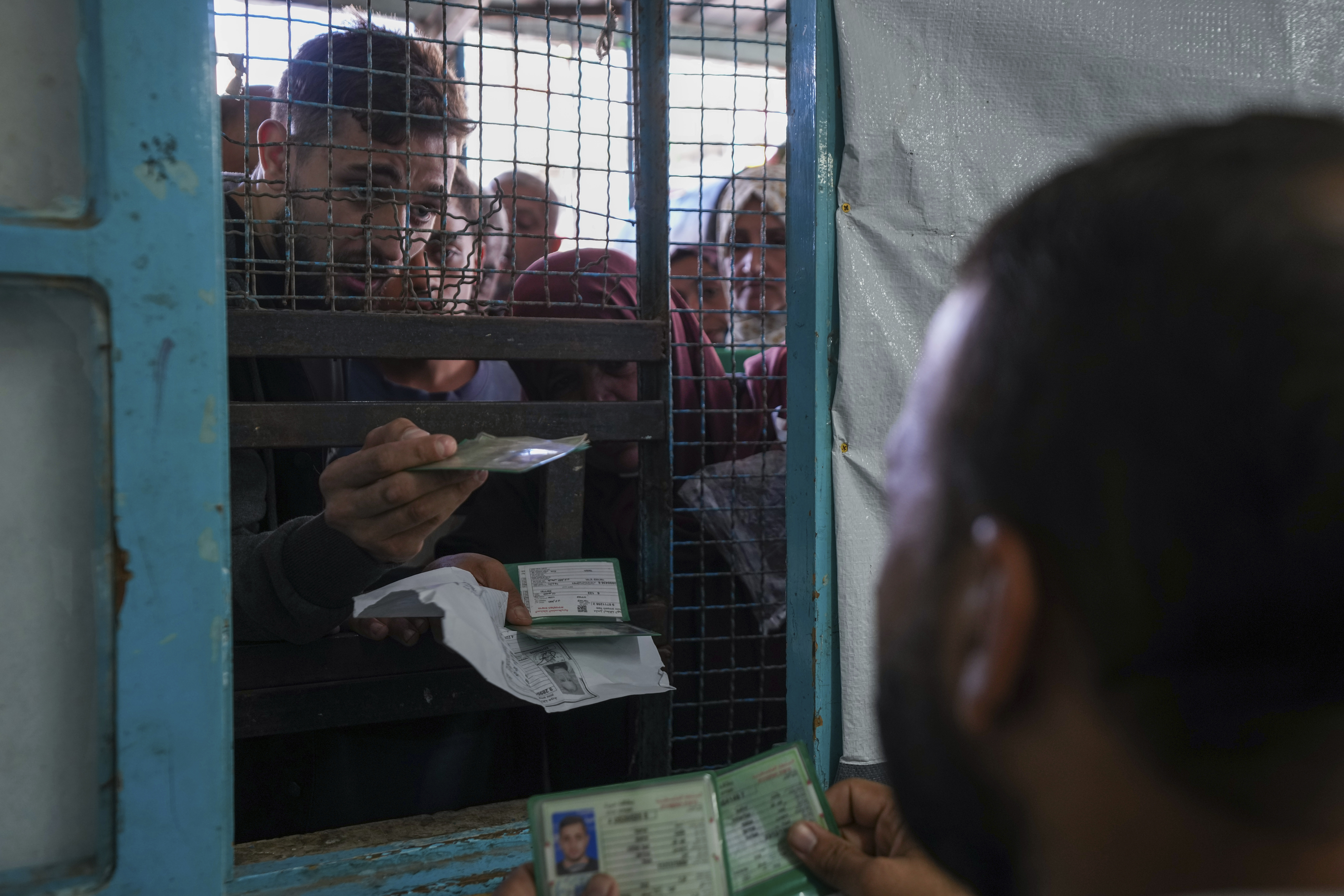 FILE - Palestinians line up to receive aid distributed by UNRWA, the U.N. agency helping Palestinian refugees, in Nusairat refugee camp, Gaza, on Nov. 5, 2024. (AP Photo/Abdel Kareem Hana, File)