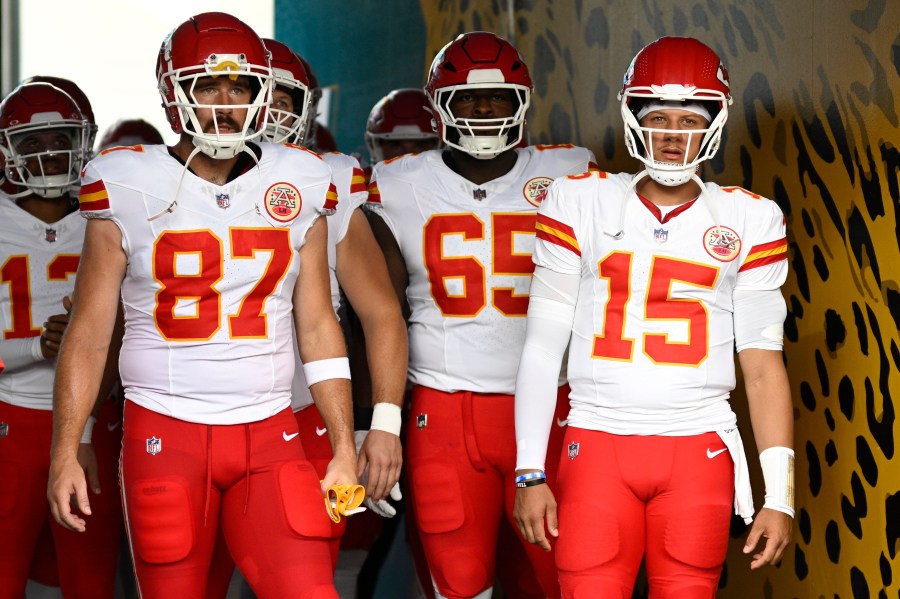 FILE - Kansas City Chiefs tight end Travis Kelce (87) and quarterback Patrick Mahomes (15) wait to lead the team onto the field before a preseason NFL football game against the Jacksonville Jaguars, Aug. 10, 2024, in Jacksonville, Fla. (AP Photo/Phelan M. Ebenhack, File)