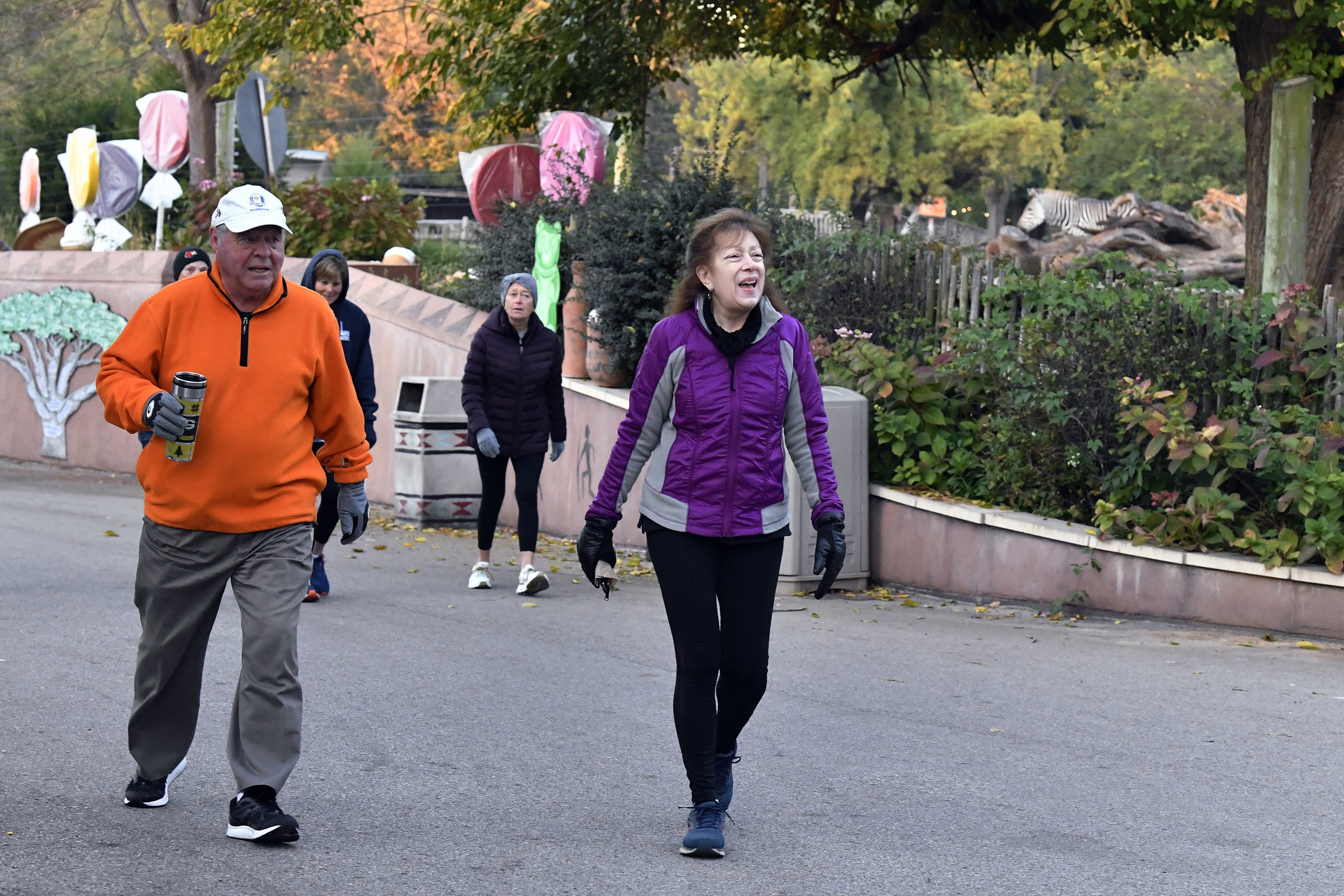 Members of the Get Healthy Walking Club walk the paths past the animal enclosures during the morning at the Louisville Zoo in Louisville, Ky., Friday, Oct. 18, 2024. (AP Photo/Timothy D. Easley)