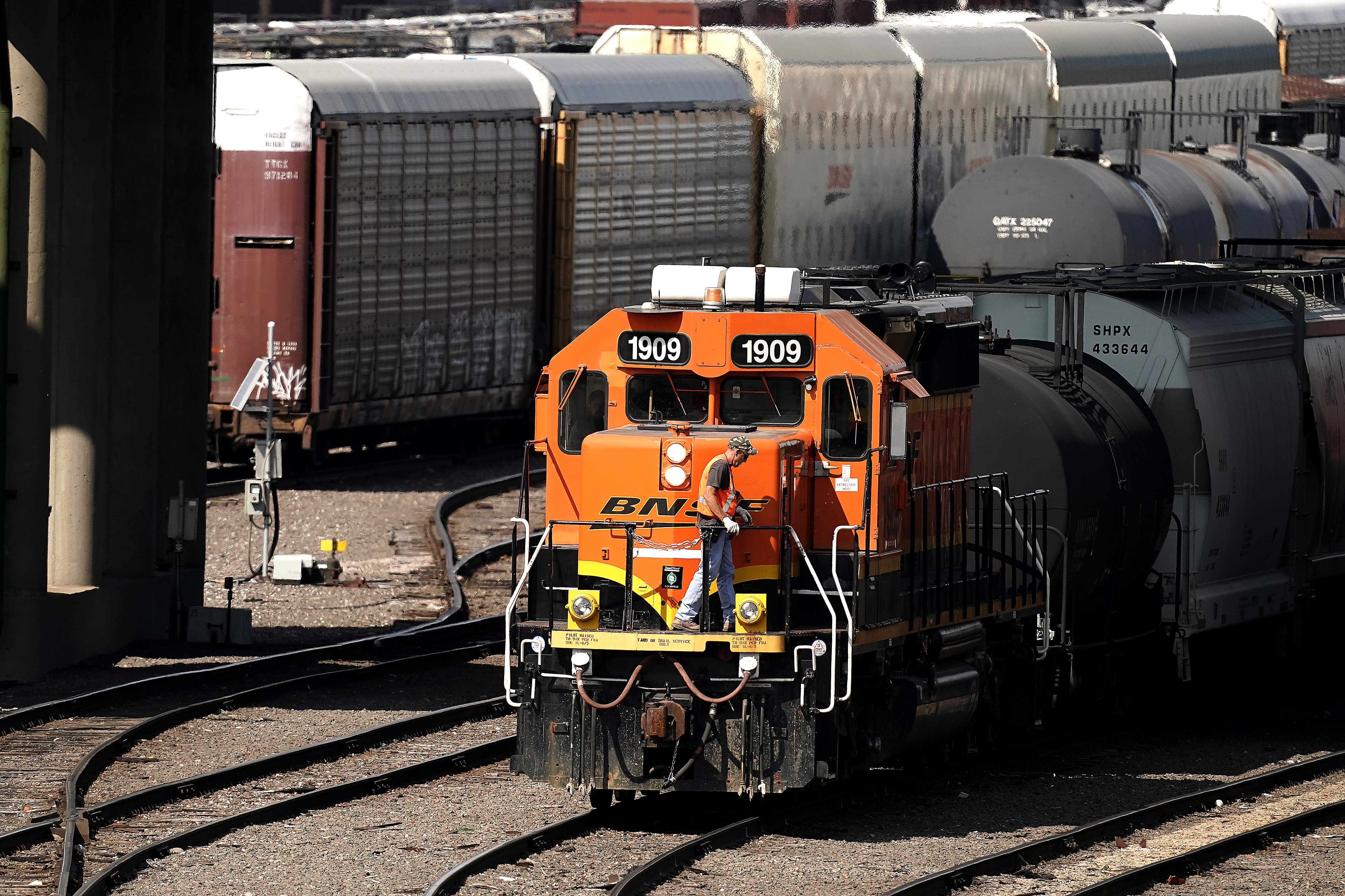 FILE - A worker boards a locomotive at a BNSF rail yard, Sept. 14, 2022, in Kansas City, Kan. (AP Photo/Charlie Riedel, File)