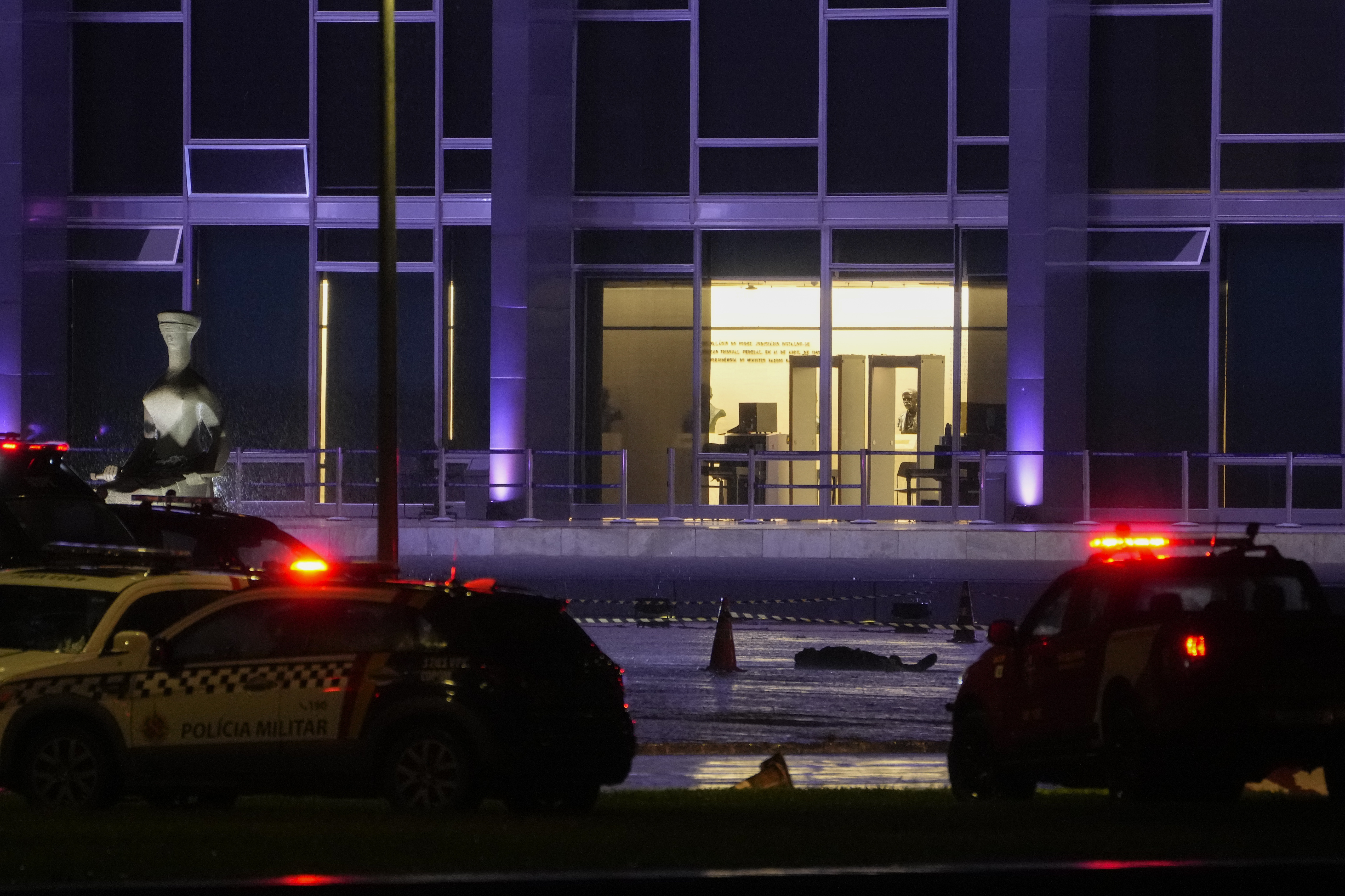 A body lies outside the Supreme Court in Brasília, Brazil, following an explosion, Wednesday, Nov. 13, 2024. (AP Photo/Eraldo Peres)