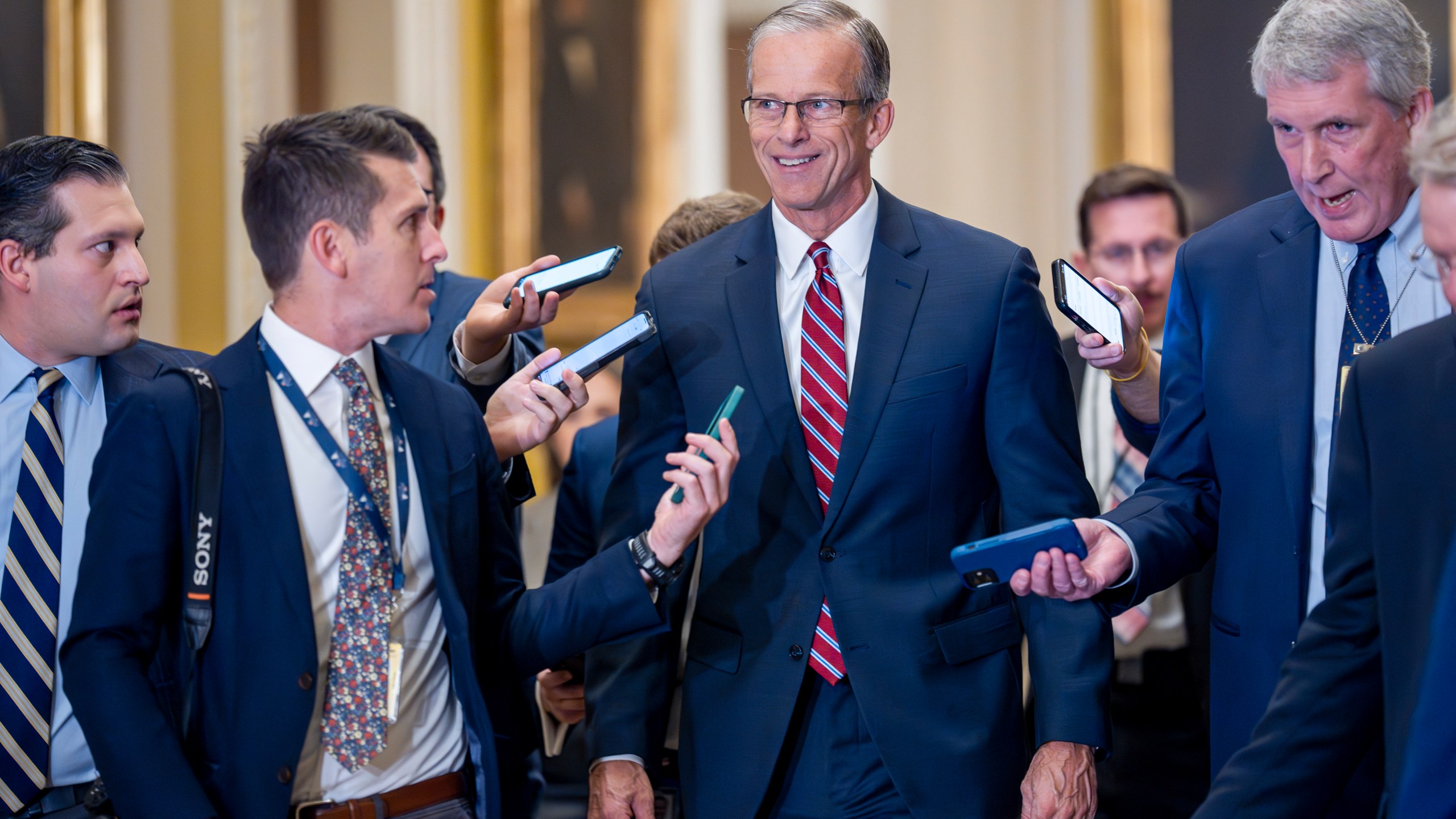 Senate Minority Whip John Thune, R-S.D., walks with reporters on the way to being elected to succeed longtime GOP leader Mitch McConnell of Kentucky, at the Capitol in Washington, Wednesday, Nov. 13, 2024.