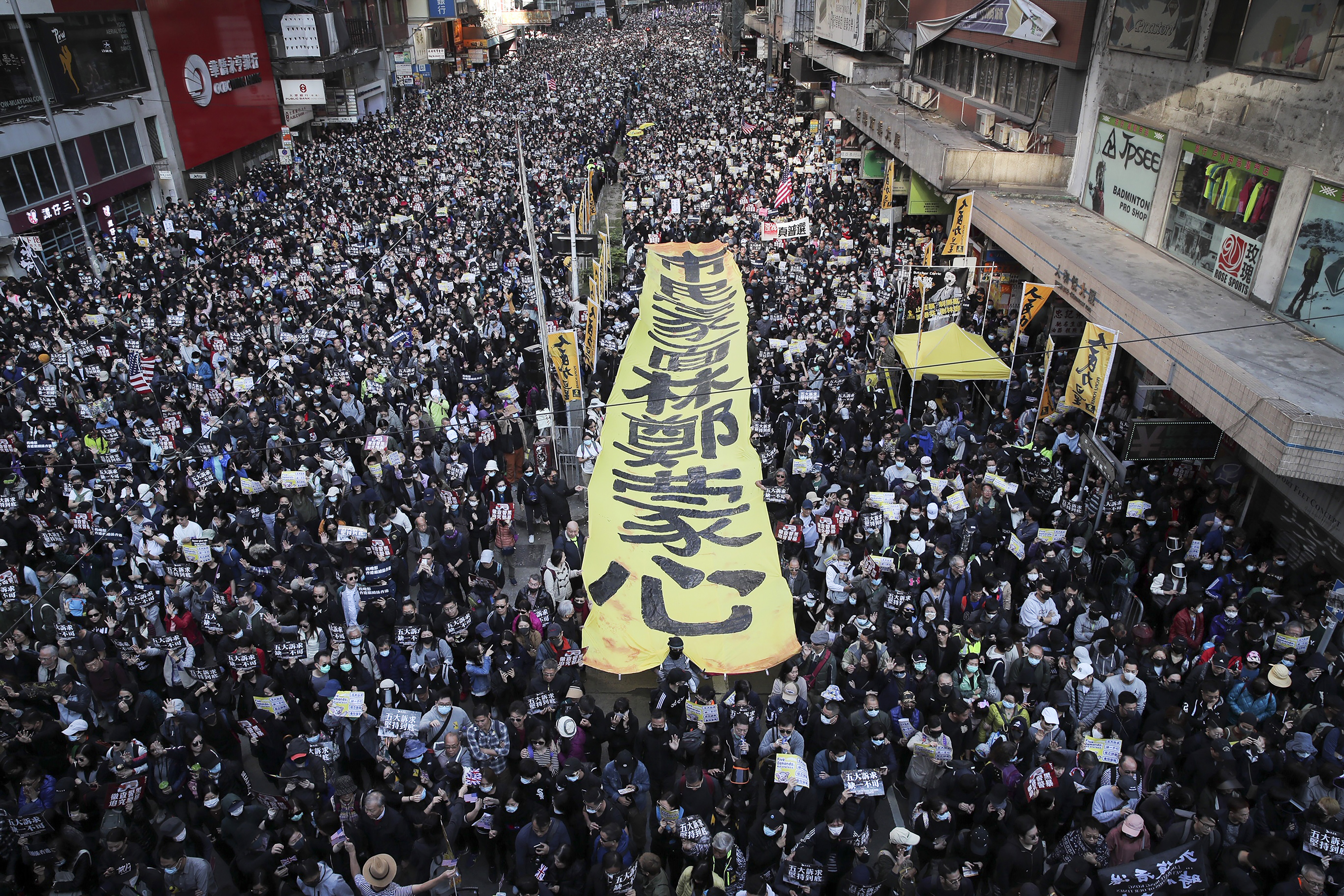 FILE - Pro-democracy protesters march on a street during a protest in Hong Kong, on Dec. 8, 2019. (AP Photo/Kin Cheung, File)