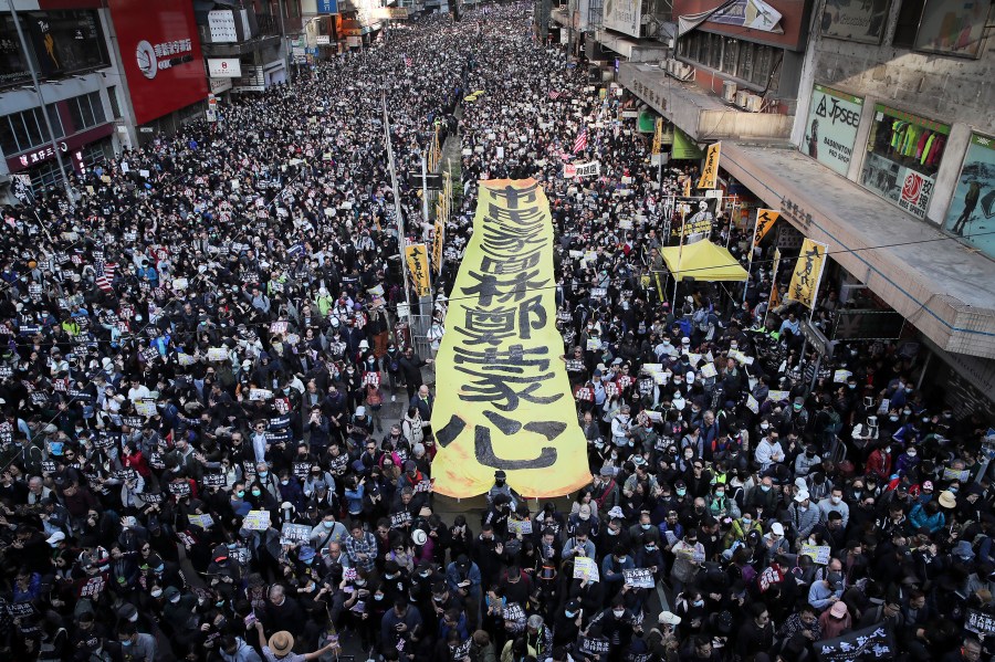 FILE - Pro-democracy protesters march on a street during a protest in Hong Kong, on Dec. 8, 2019. (AP Photo/Kin Cheung, File)