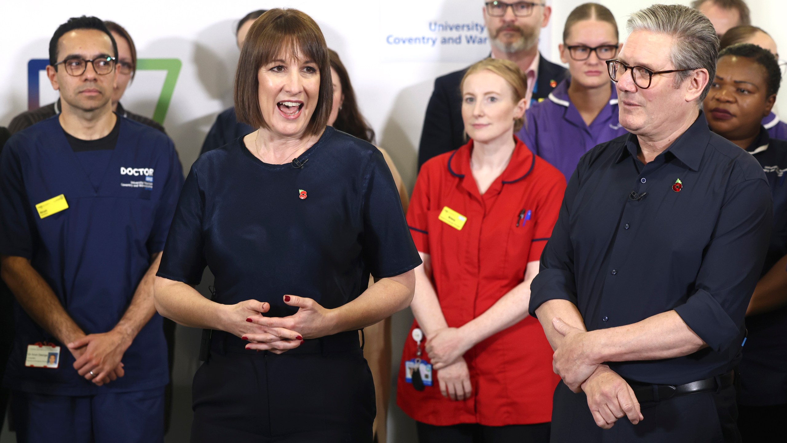 Britain's Prime Minister Keir Starmer and Chancellor Rachel Reeves speak with members of staff, during a visit to University Hospital Coventry and Warwickshire, in Coventry, England, Thursday, Oct. 31, 2024. (AP Photo/Darren Staples, pool)