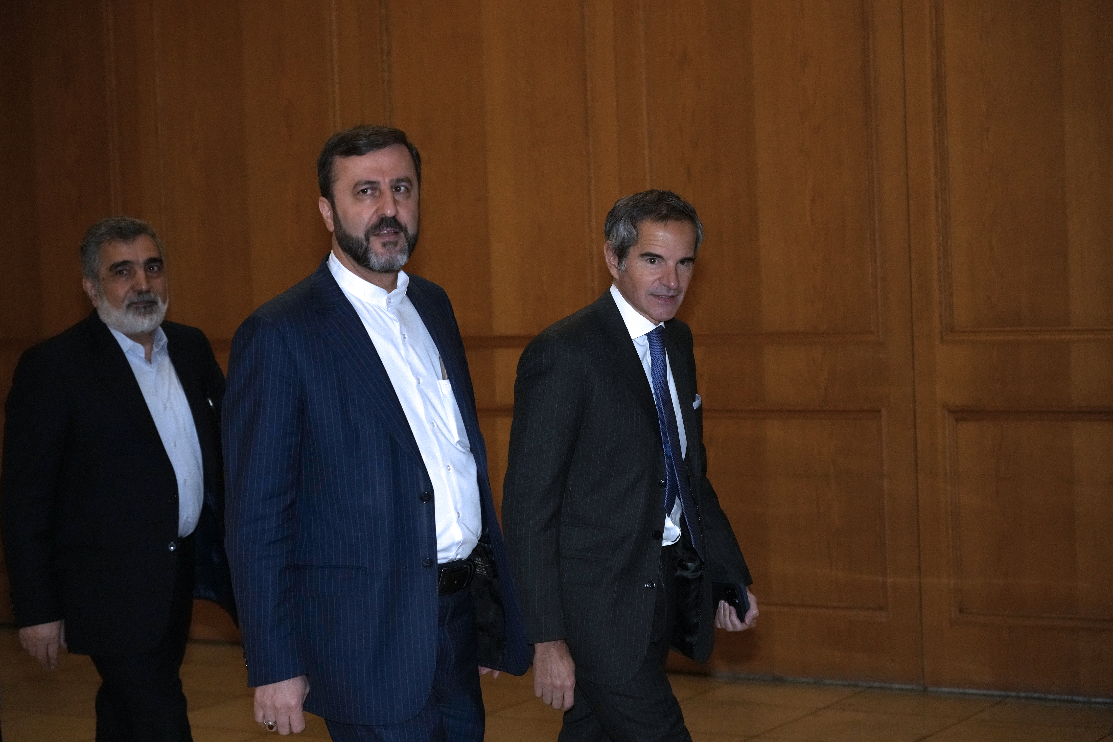 International Atomic Energy Agency (IAEA) Director General Rafael Mariano Grossi, right, arrives for a meeting with Iranian Foreign Minister Abbas Araghchi, unseen, as he is accompanied by Deputy Foreign Minister Kazem Gharib Abadi, second right, and Deputy Chief of Atomic Energy Organization of Iran, Behrouz Kamalvandi in Tehran, Iran, Thursday, Nov. 14, 2024. (AP Photo/Vahid Salemi)