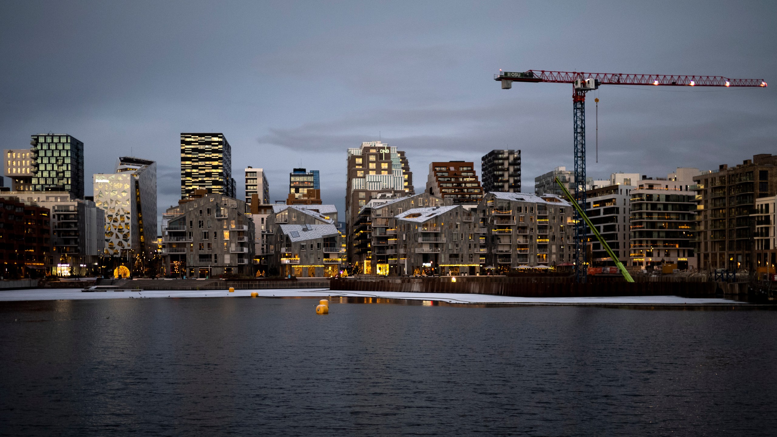 FILE - The sun reflected in the windows of the skyline of the so called 'Barcode Project' neighborhood at dusk in Oslo, Norway, on Dec. 8, 2022. (AP Photo/Markus Schreiber, File)