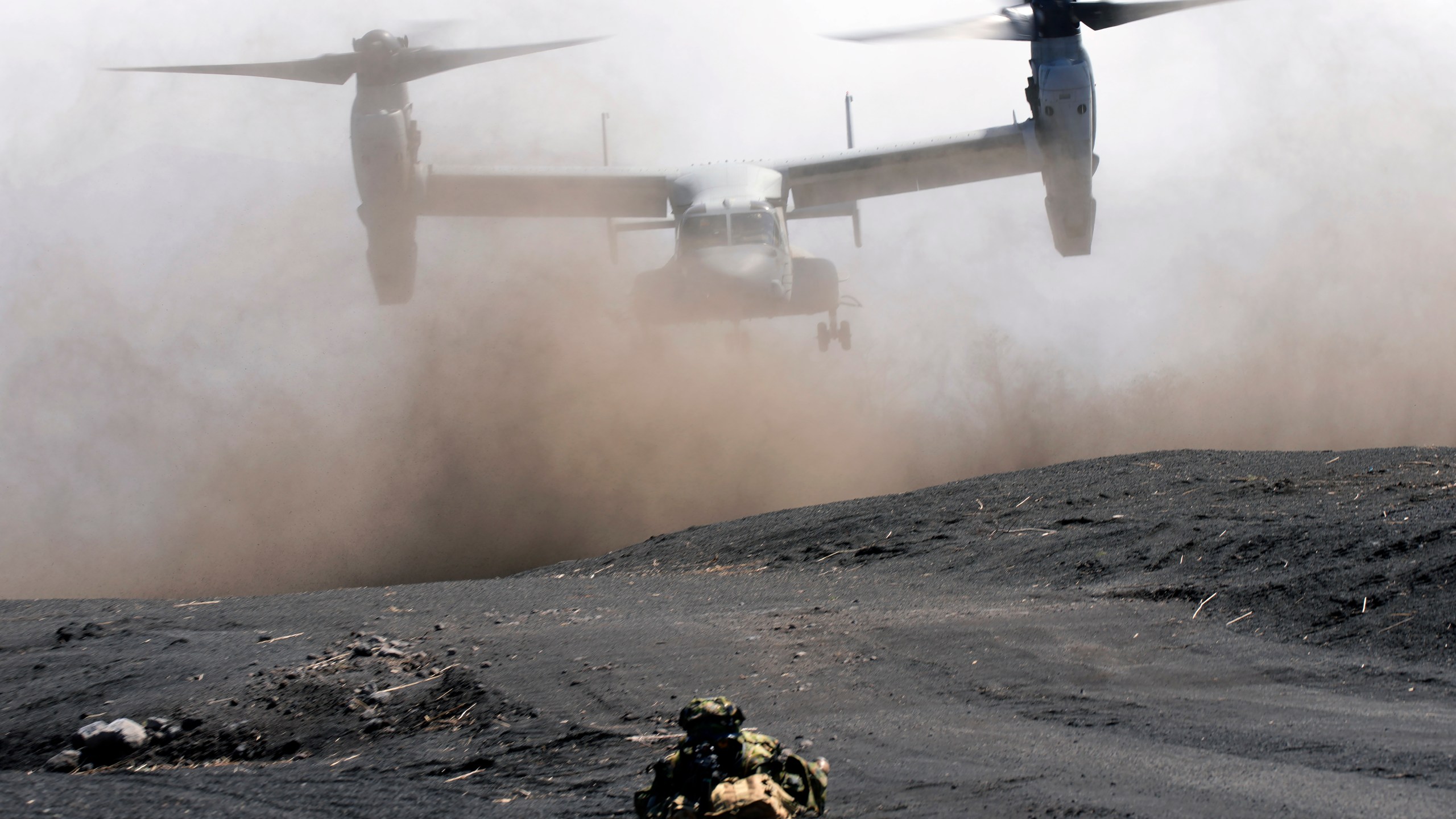 FILE - An MV-22 Osprey takes off as Japan Ground Self-Defense Force guards the landing zone during a joint military drill with U.S. Marines in Gotemba, southwest of Tokyo, March 15, 2022. (AP Photo/Eugene Hoshiko, File)