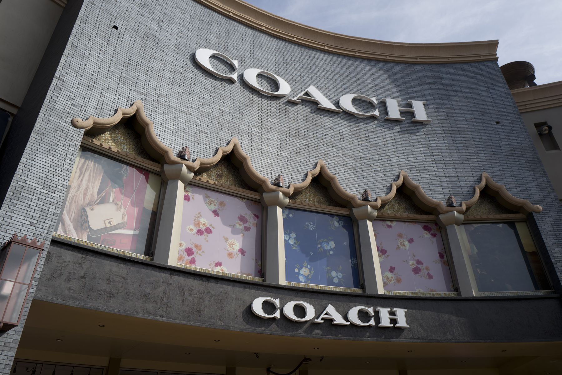 FILE - A chain of the Coach brand, owned by parent company Tapestry, is seen, May 3, 2019, at the Citadel Outlets in Commerce, Calif. (AP Photo/Richard Vogel, File)