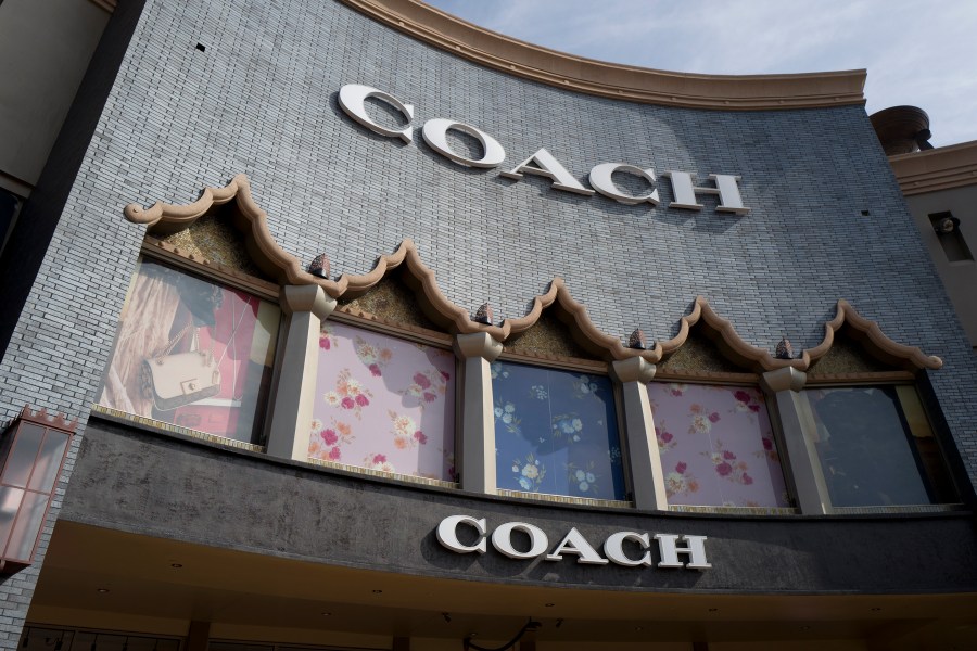 FILE - A chain of the Coach brand, owned by parent company Tapestry, is seen, May 3, 2019, at the Citadel Outlets in Commerce, Calif. (AP Photo/Richard Vogel, File)