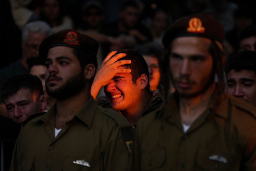 Mourners react during eulogies for Israeli soldier Capt. Itay Marcovich, who was killed in action in Lebanon, during his funeral in Kokhav Yair, Israel, Thursday, Nov. 14, 2024. (AP Photo/Ohad Zwigenberg)