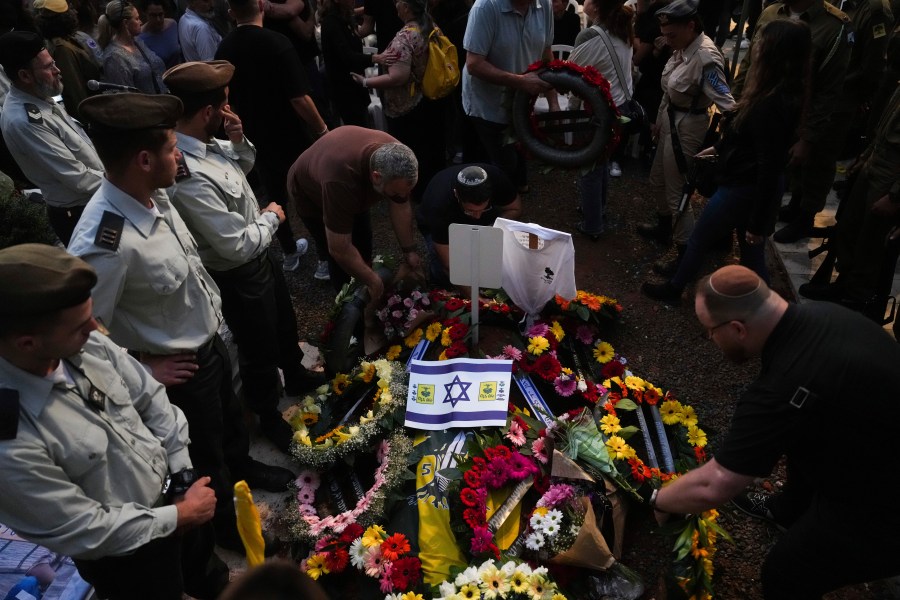 Mourners gather around the grave of Israeli soldier Capt. Itay Marcovich, who was killed in action in Lebanon, during his funeral in Kokhav Yair, Israel, Thursday, Nov. 14, 2024. (AP Photo/Ohad Zwigenberg)