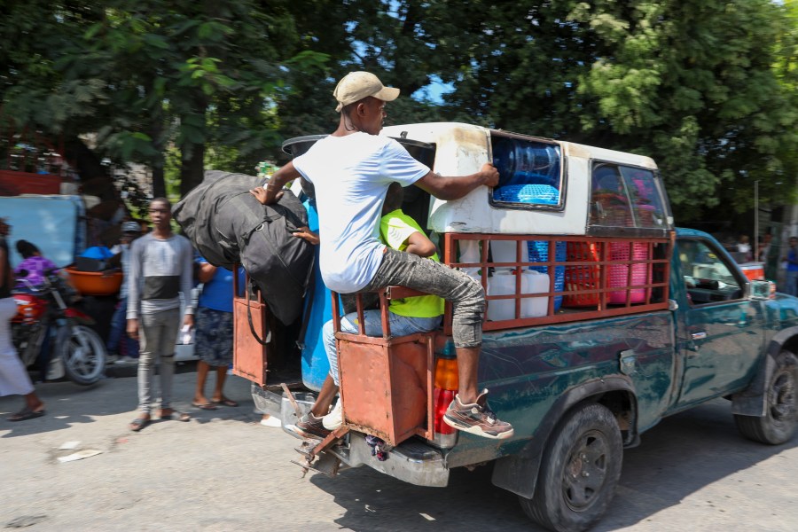 Residents flee their homes to escape gang violence in the Nazon neighborhood of Port-au-Prince, Haiti, Thursday, Nov. 14, 2024. (AP Photo/Odelyn Joseph)