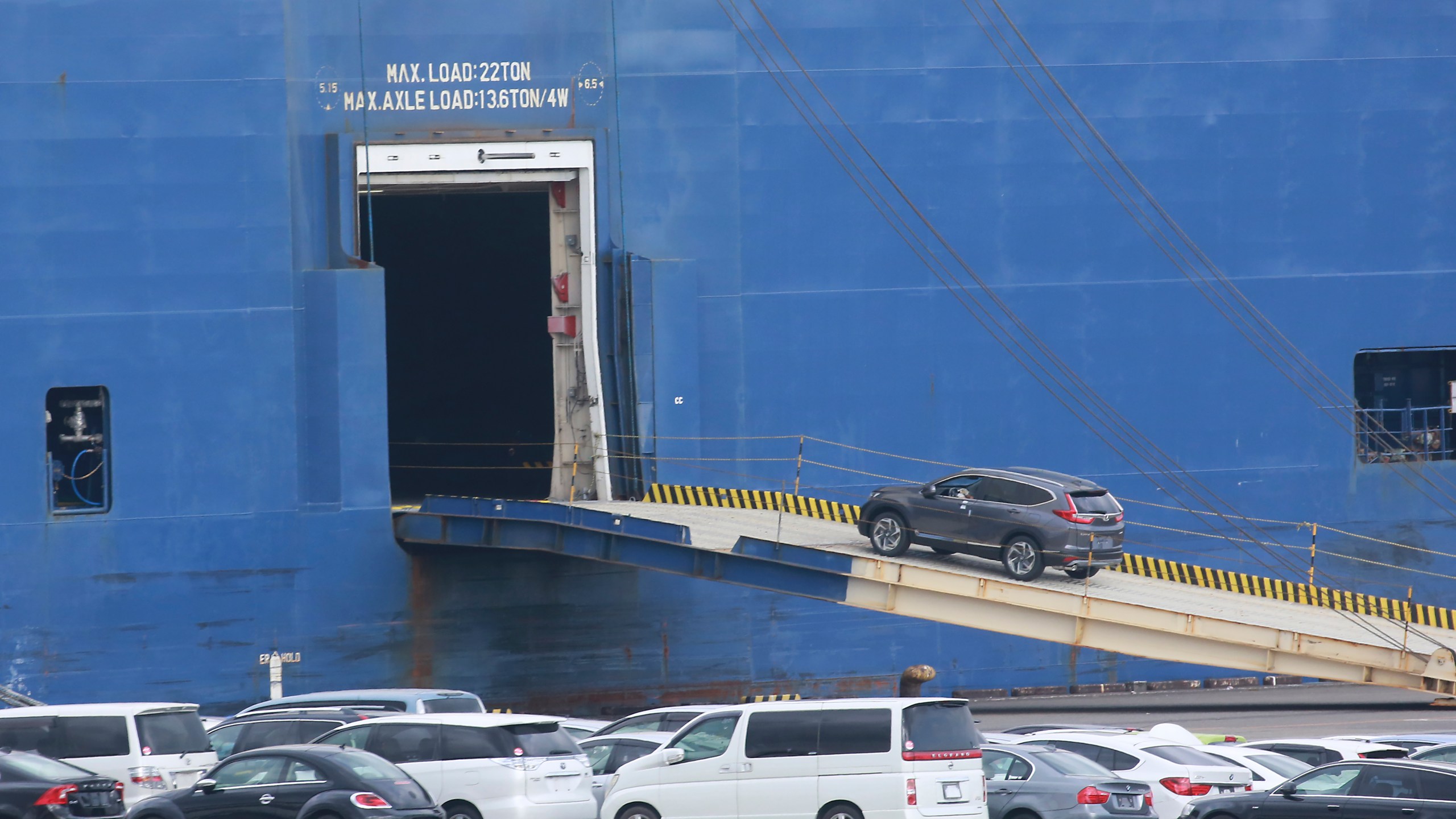 FILE - Cars for export are loaded onto a cargo ship at a port in Yokohama, near Tokyo, Nov. 2, 2021. (AP Photo/Koji Sasahara, File)