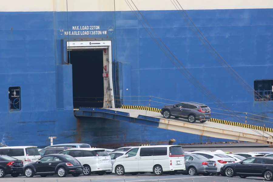 FILE - Cars for export are loaded onto a cargo ship at a port in Yokohama, near Tokyo, Nov. 2, 2021. (AP Photo/Koji Sasahara, File)