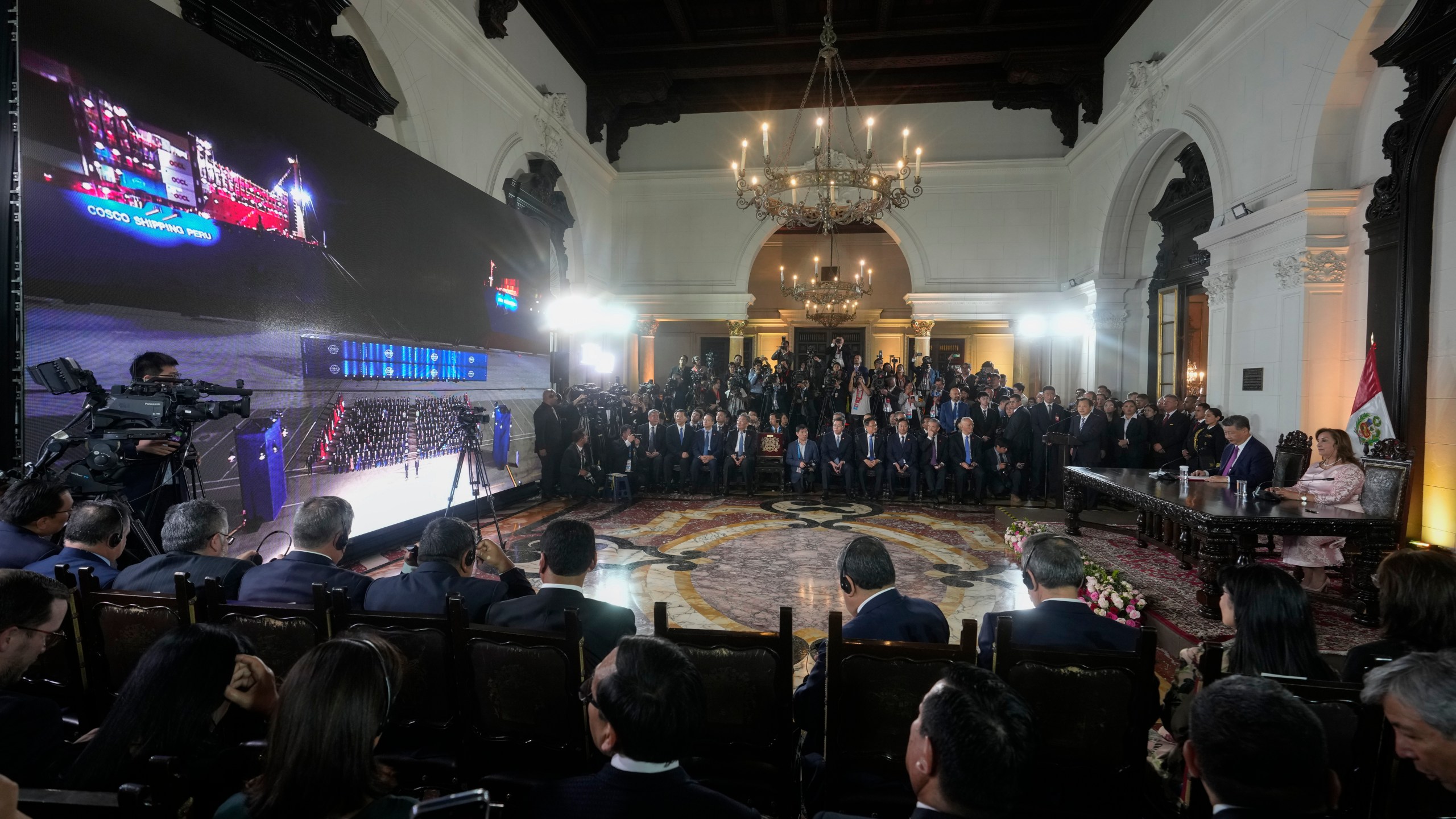 Peru's President Dina Boluarte and Chinese President Xi Jinping, both right, watch the inauguration of a Chinese-funded port in the city of Chancay, during a virtual ceremony at the government palace in Lima, Peru, Thursday, Nov. 14, 2024. (AP Photo/Fernando Vergara)