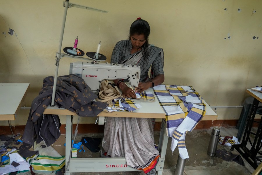 H. Gauri, 32, uses an electric sewing machine to stitch a cloth pouch in a small garage at the campus of the Swami Vivekananda Youth Movement, a nongovernmental organization that works to help poor and Indigenous communities, in Kenchanahalli, India, Monday, Sept. 23, 2024. (AP Photo/Aijaz Rahi)