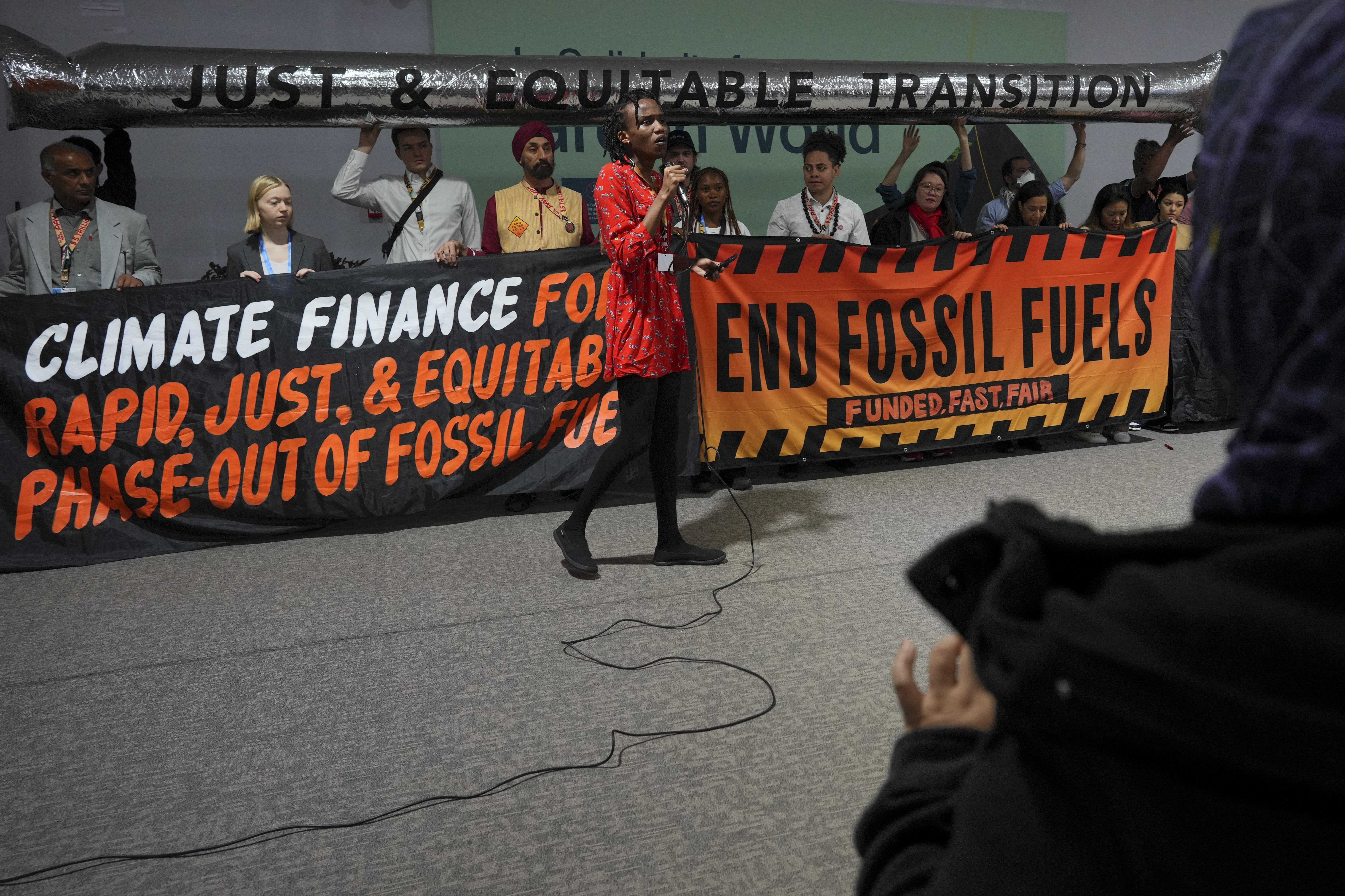 Eric Njuguna, of Kenya, participates in a demonstration against fossil fuels at the COP29 U.N. Climate Summit, Friday, Nov. 15, 2024, in Baku, Azerbaijan. (AP Photo/Peter Dejong)