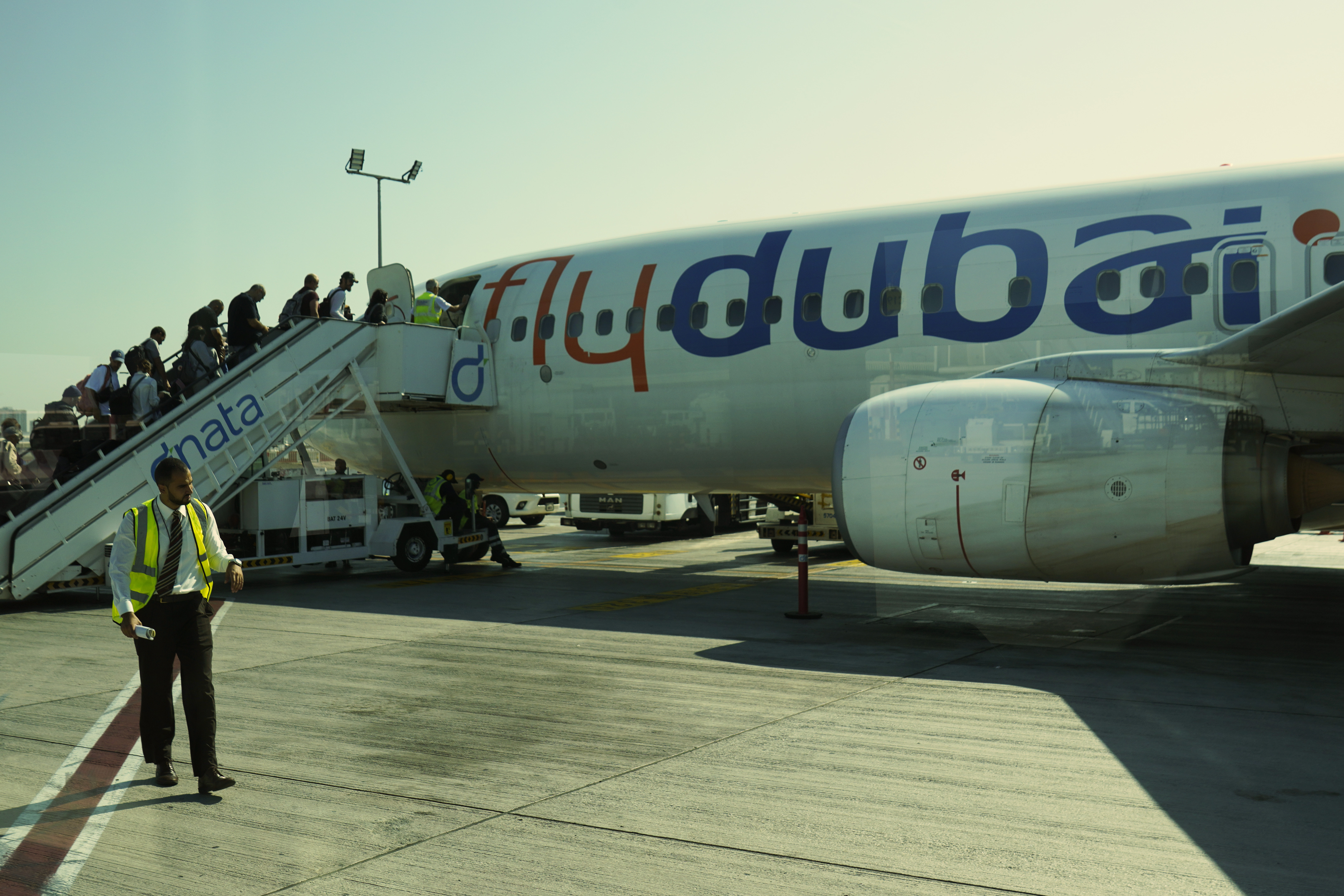 Passengers for a FlyDubai flight heading to Ben Gurion International Airport in Israel board their aircraft at Dubai International Airport in Dubai, United Arab Emirates, Friday, Oct. 18, 2024. (AP Photo/Jon Gambrell)