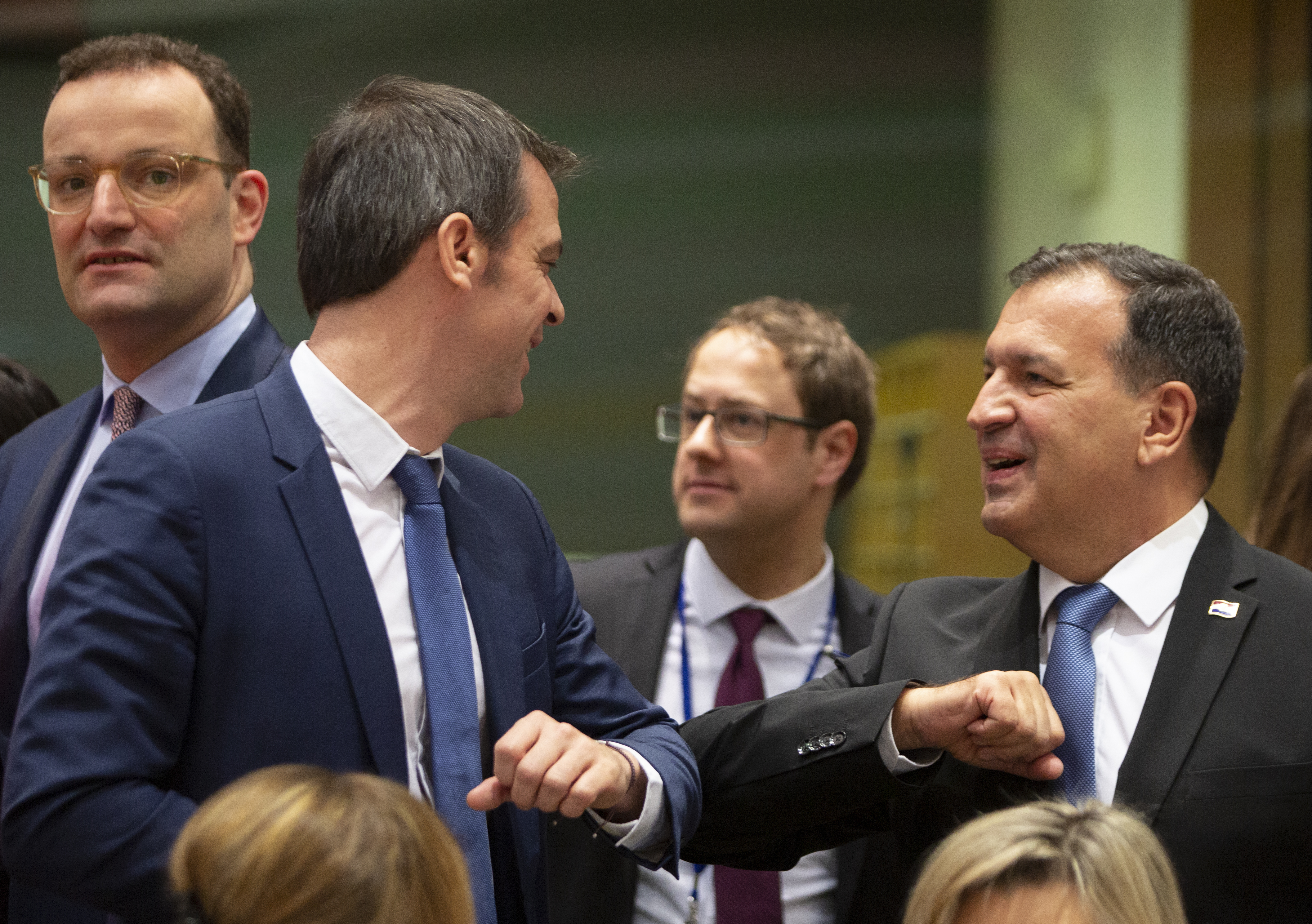 FILE -Croatian Health Minister Vili Beros, right, bumps elbows to say hello to French Health Minister Olivier Veran during an extraordinary meeting of EU health ministers in Brussels to discuss the virus outbreak, March 6, 2020. (AP Photo/Virginia Mayo, File)