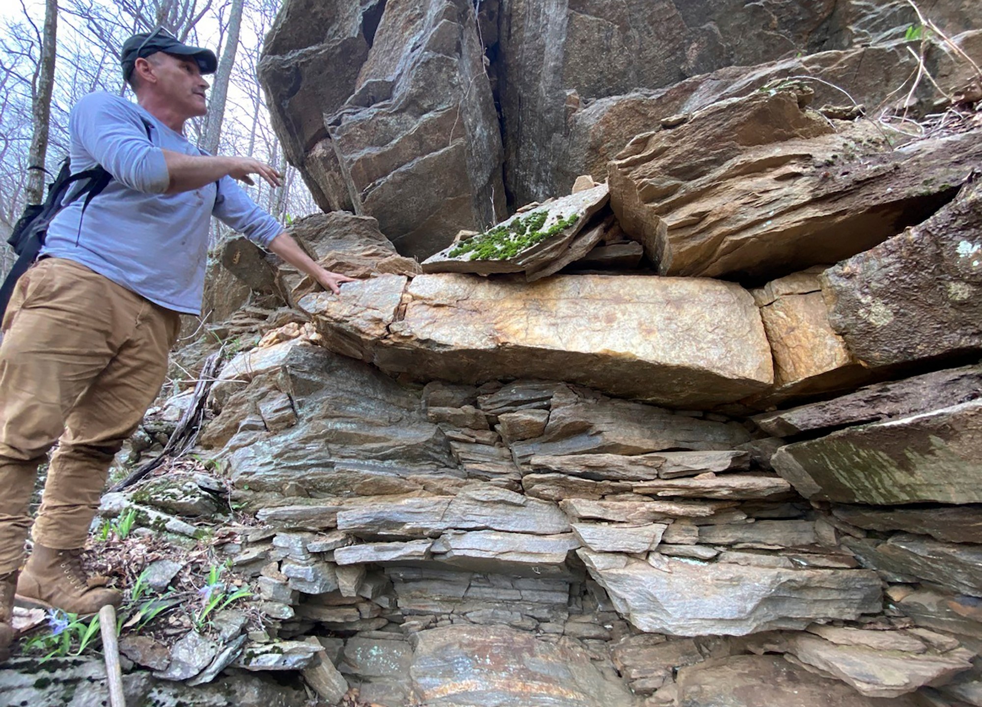 This April 16, 2024, photo provided by Philip LaPorta shows Scott Ashcraft, an archaeologist and heritage resources program manager for the Pisgah National Forest, examining a quartz vein at a prehistoric quarry site near Asheville, North Carolina. (Philip LaPorta via AP)