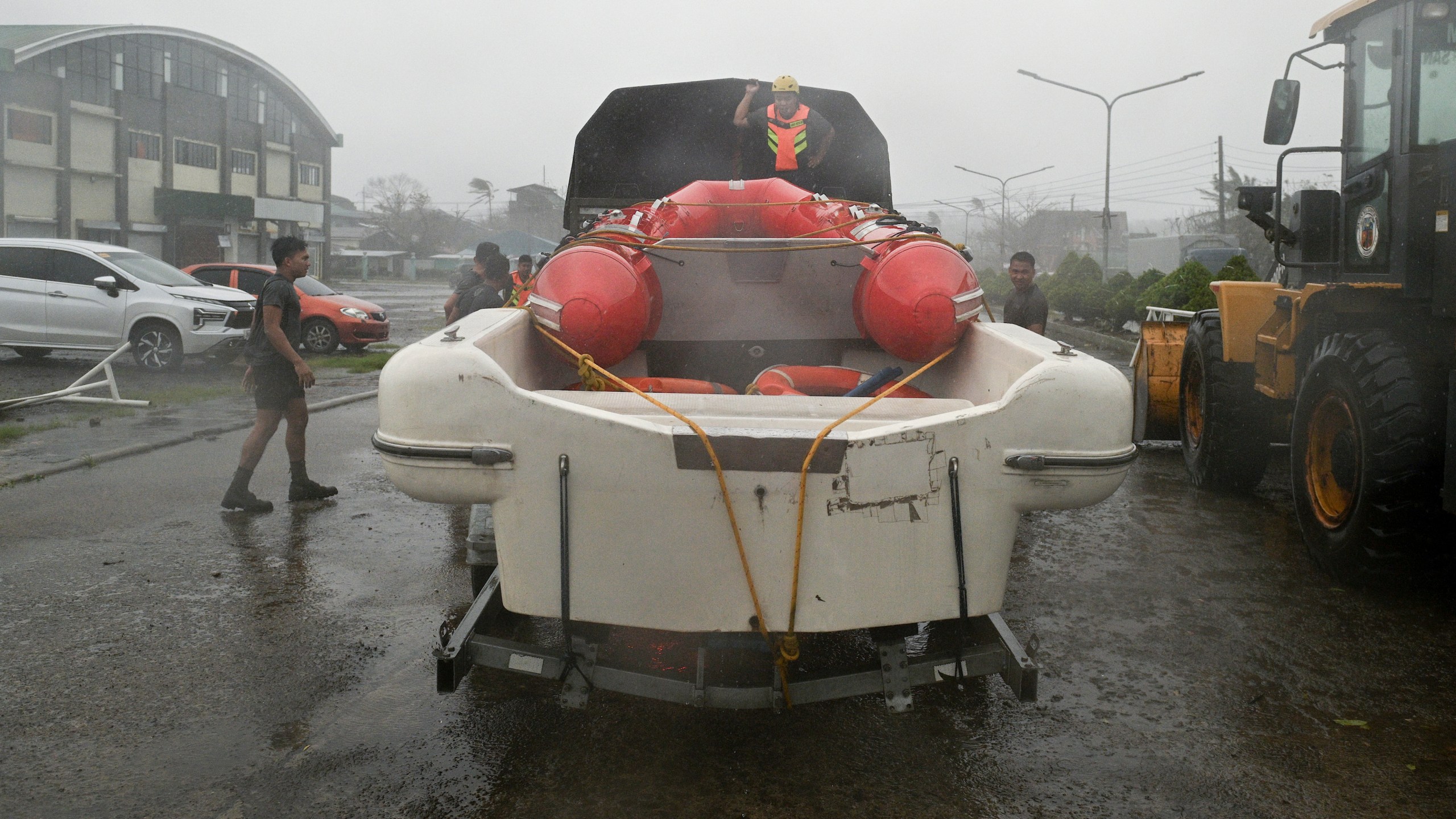 Rescuers prepare a boat during rains caused by Typhoon Usagi at Santa Ana, Cagayan province, northern Philippines on Thursday, Nov. 14, 2024. (AP Photo/Noel Celis)