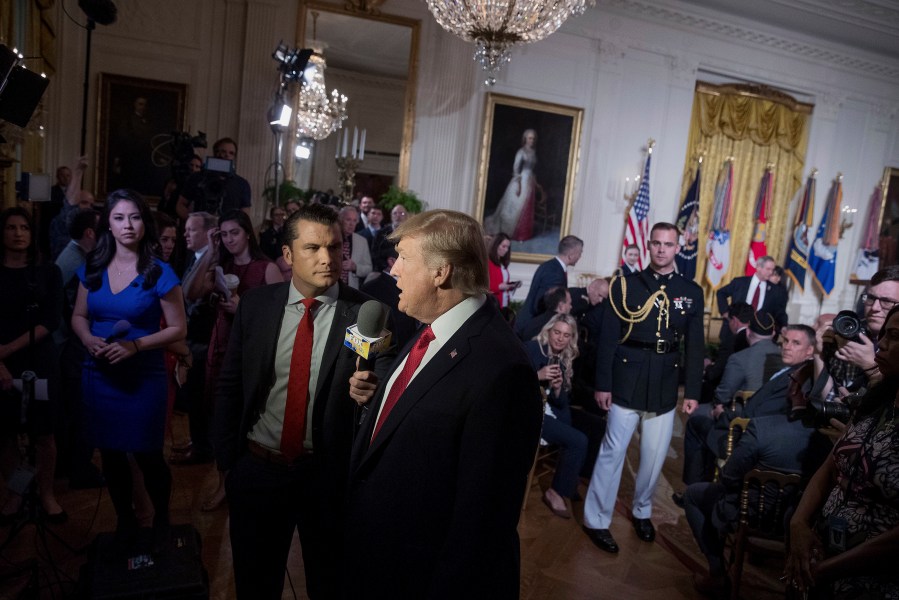 FILE - President Donald Trump appears on Fox & Friends co-host Pete Hegseth at a Wounded Warrior Project Soldier Ride event in the East Room of the White House in Washington, Thursday, April 6, 2017. (AP Photo/Andrew Harnik, File)