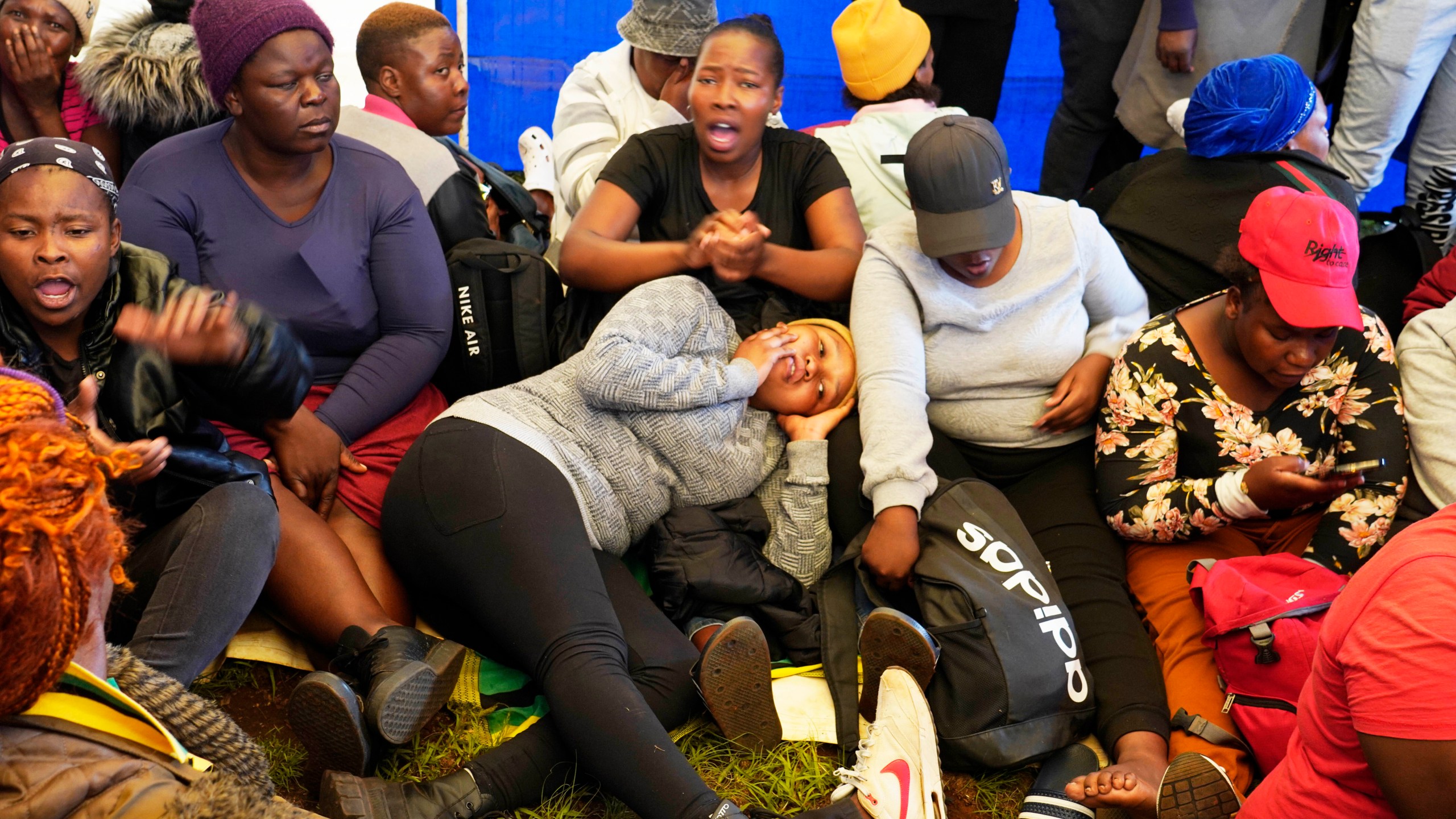 Relatives and friends wait for news near a reformed gold mineshaft where illegal miners are trapped in Stilfontein, South Africa, Friday, Nov. 15, 2024. (AP Photo/Denis Farrell)