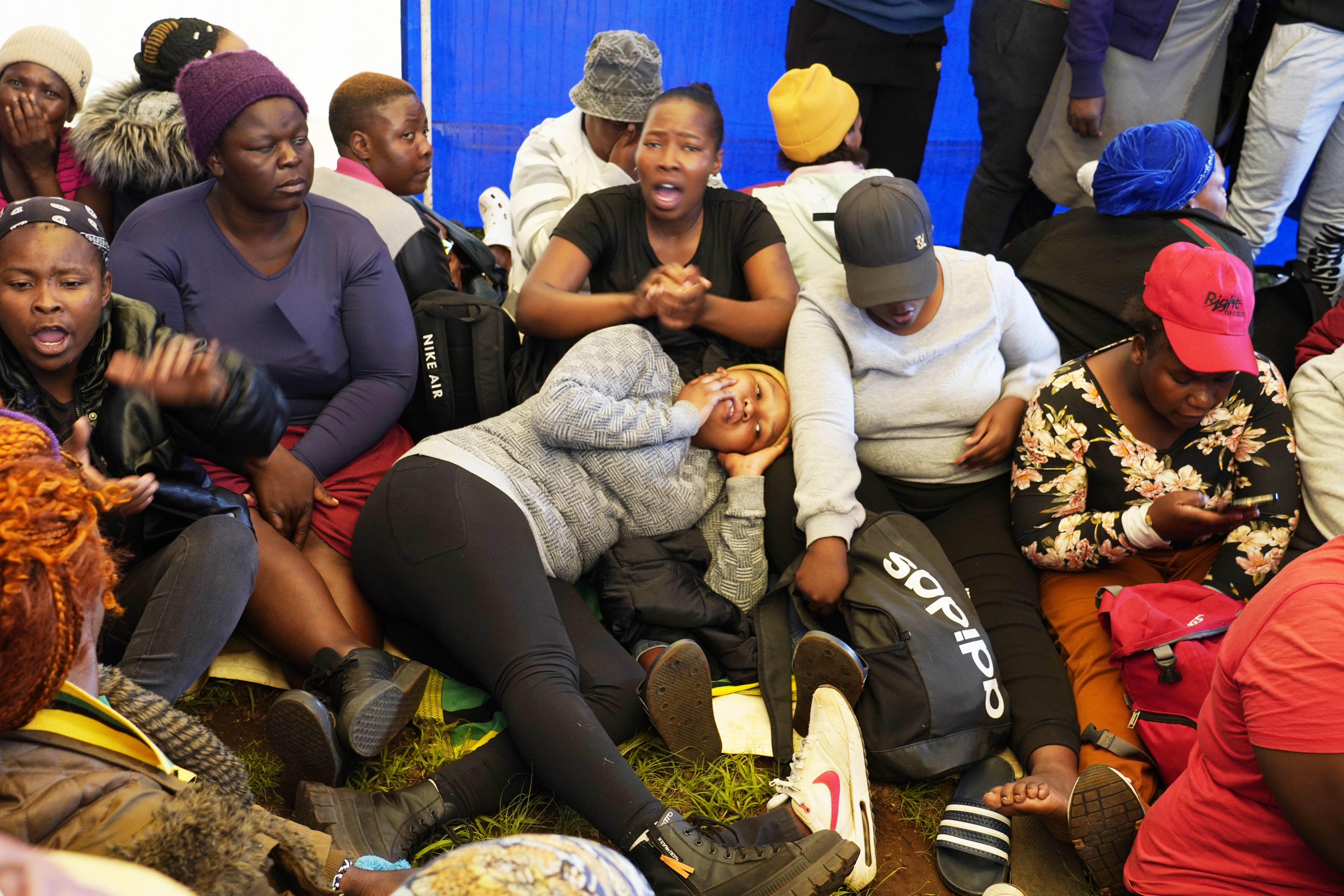 Relatives and friends wait for news near a reformed gold mineshaft where illegal miners are trapped in Stilfontein, South Africa, Friday, Nov. 15, 2024. (AP Photo/Denis Farrell)