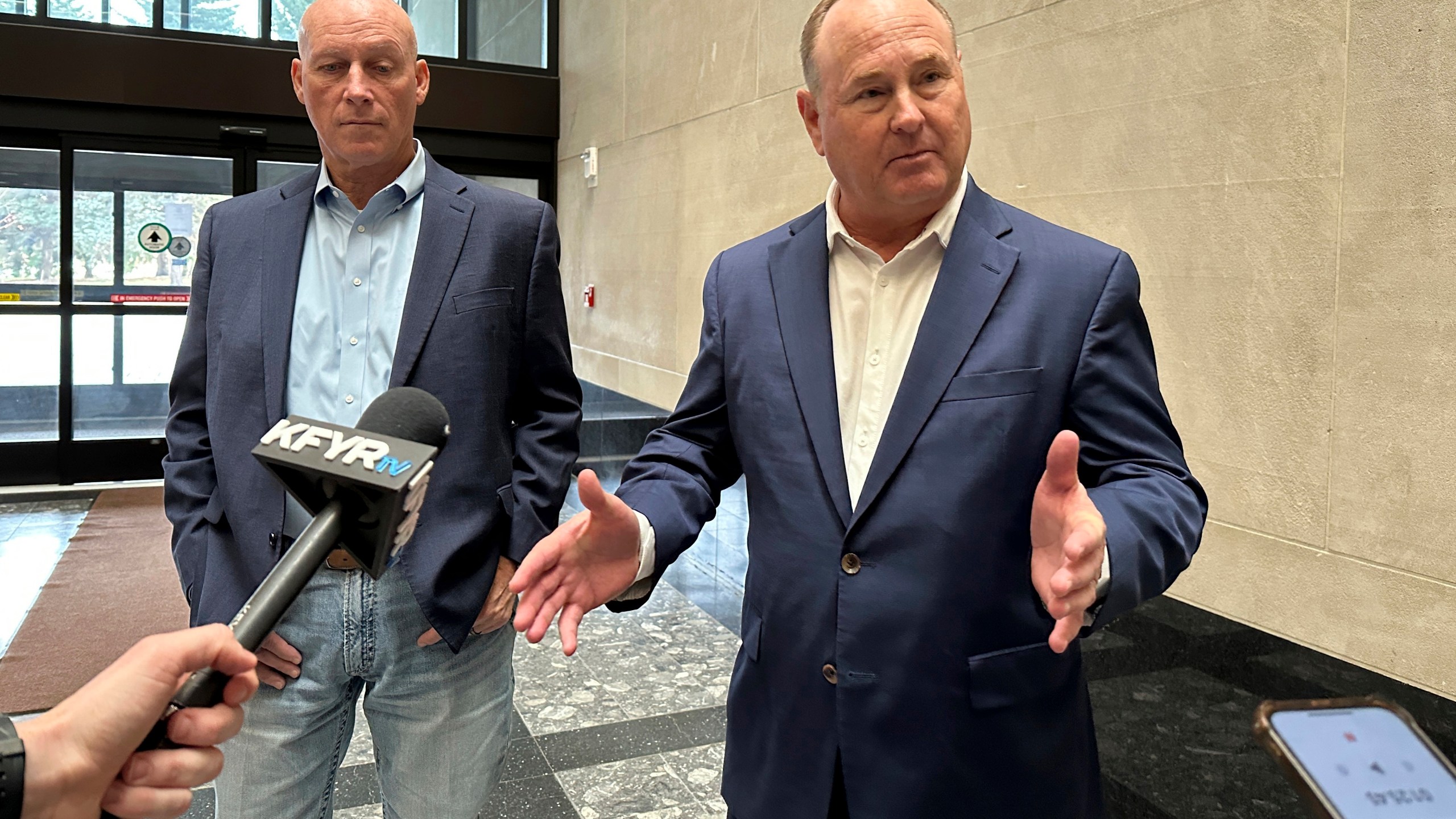 Summit Carbon Solutions CEO Lee Blank, right, talks to reporters, Friday, Nov. 15, 2024, at the state Capitol in Bismarck, N.D., after the state Public Service Commission approved a siting permit for the company's proposed North Dakota route of its planned five-state Midwest carbon dioxide pipeline. At left is Summit Chief Operating Officer Jimmy Powell. (AP Photo/Jack Dura)