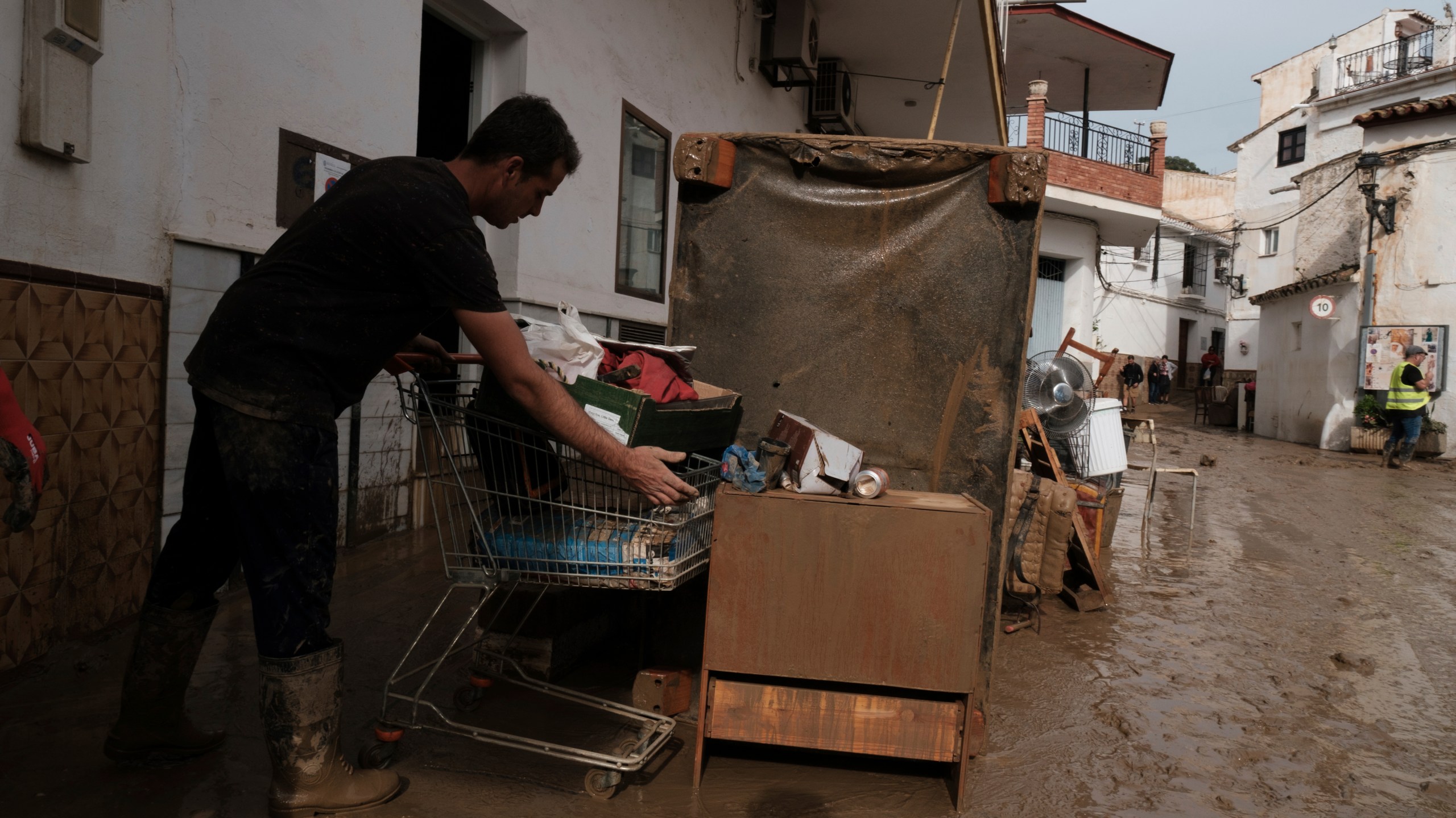 Residents remove their belongings from their houses affected by flooding in Benagarmosa, Malaga, Spain, Thursday, Nov. 14, 2024. (AP Photo/Gregorio Marrero)